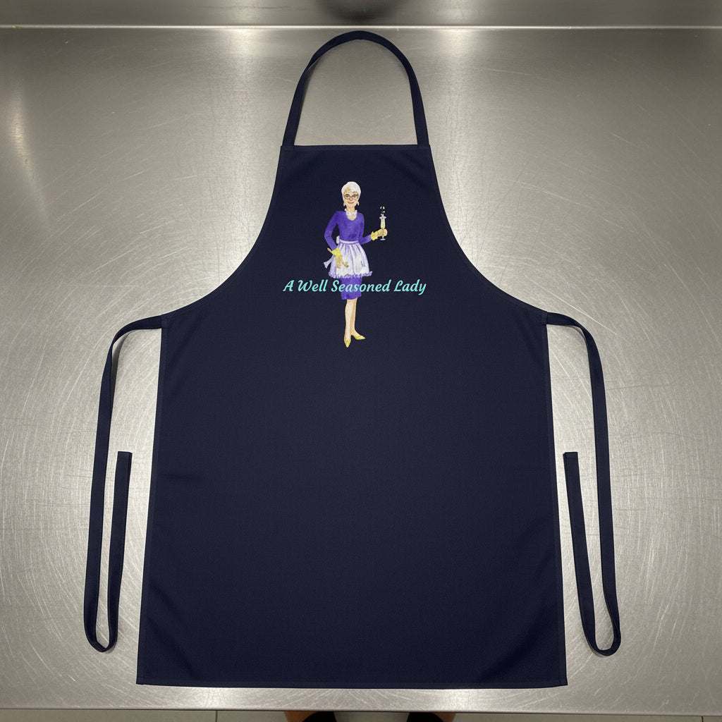 Black apron with a graphic of a woman and text 'A Well Seasoned Lady' on a white background