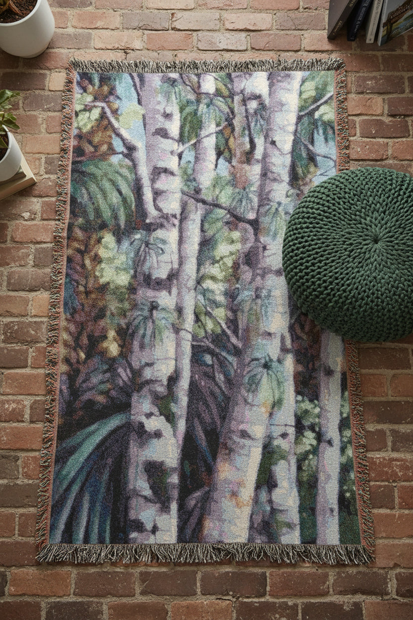 Woven blanket with nature-themed design featuring Birch Trees and foliage