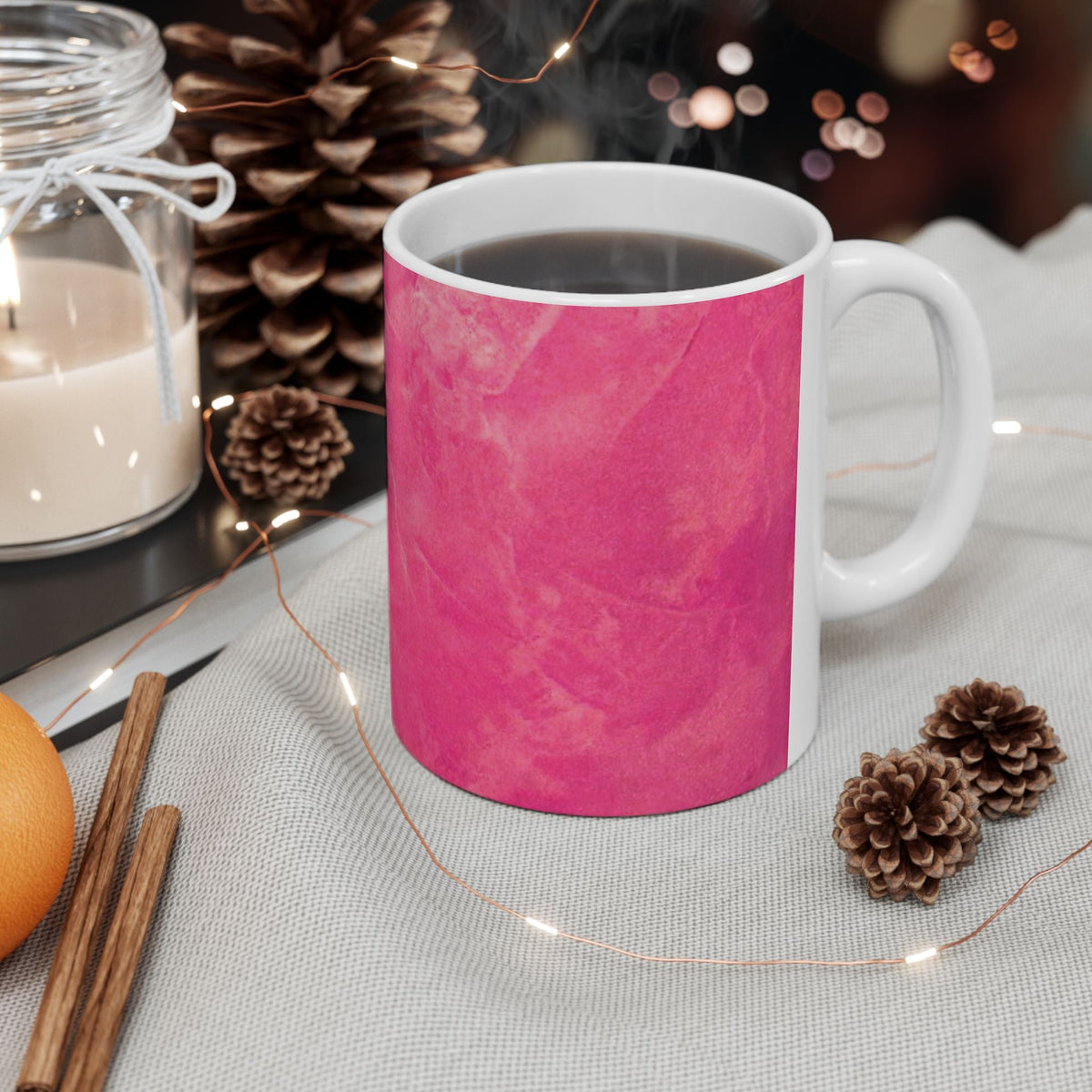 A white ceramic mug wrapped in a bright pink marbled abstract design 11oz
