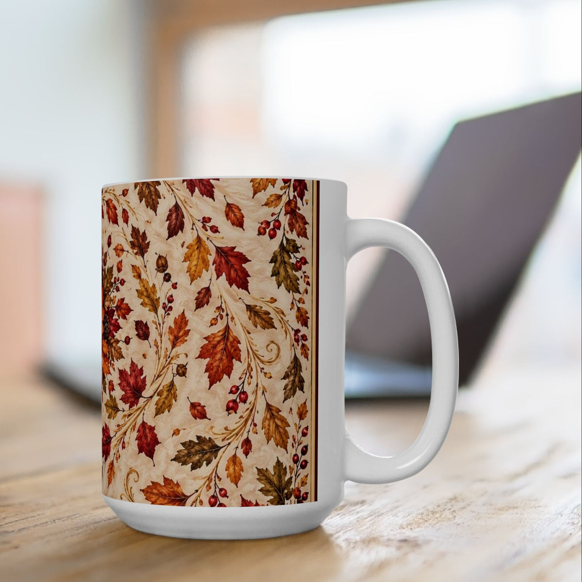 A white ceramic mug with a detailed autumn leaf pattern in red, orange, and brown on a beige background on 15oz