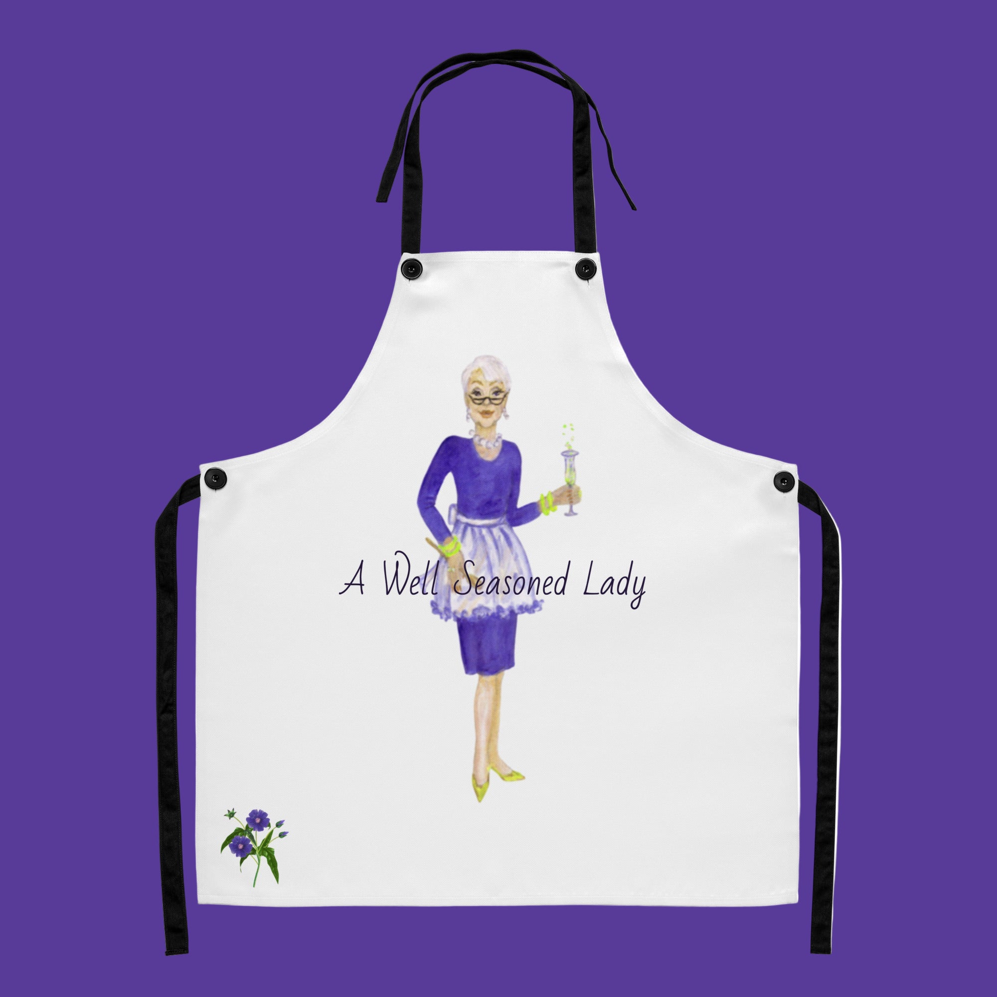 White apron with a graphic of a sophisticated lady in an apron holding a wooden spoon and a flute of champagne with a text 'A Well Seasoned Lady' on stain resistant fabric.