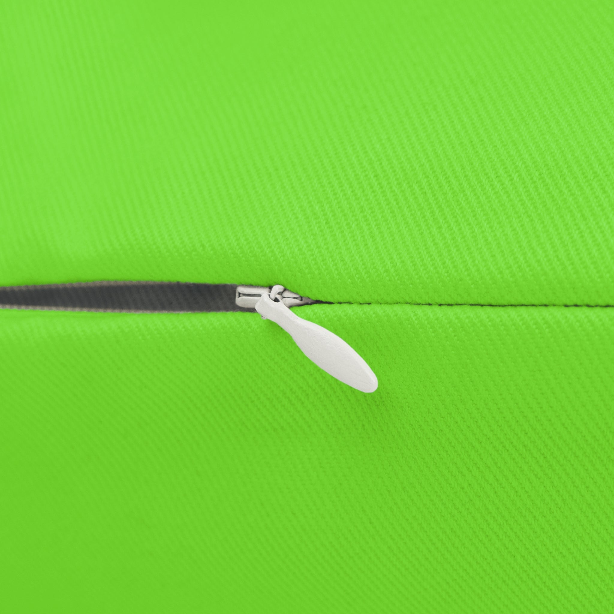 Close-up of a zipper on a green fabric of lumbar pillow