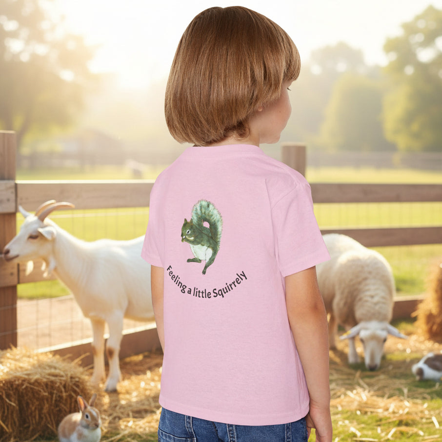 A light pink short-sleeve t-shirt, viewed from the back. The shirt features a graphic of a squirrel and the text 'Feeling a little Squirrelly'