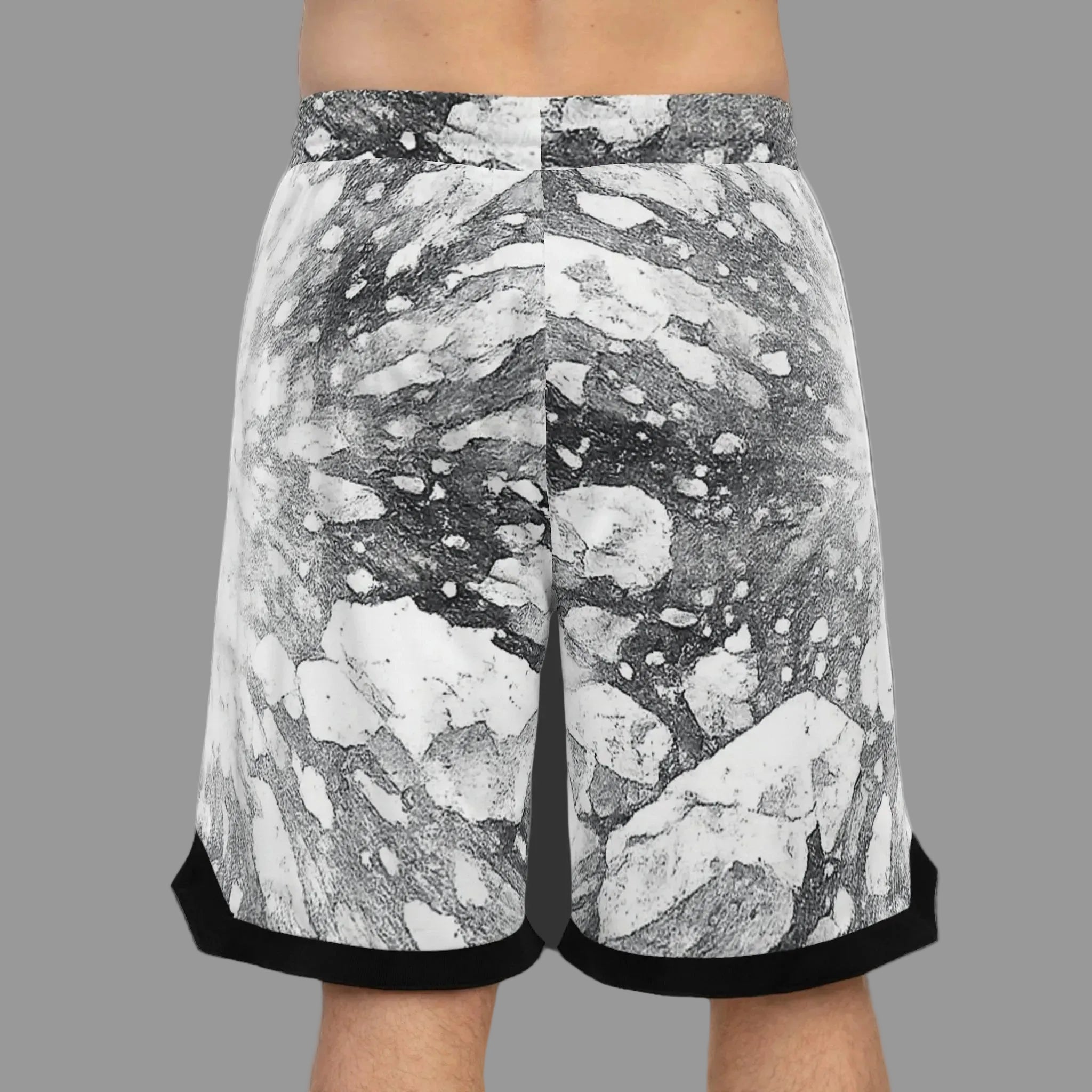 Black and white explosive graphic patterned athletic shorts with black rolled hems of back view