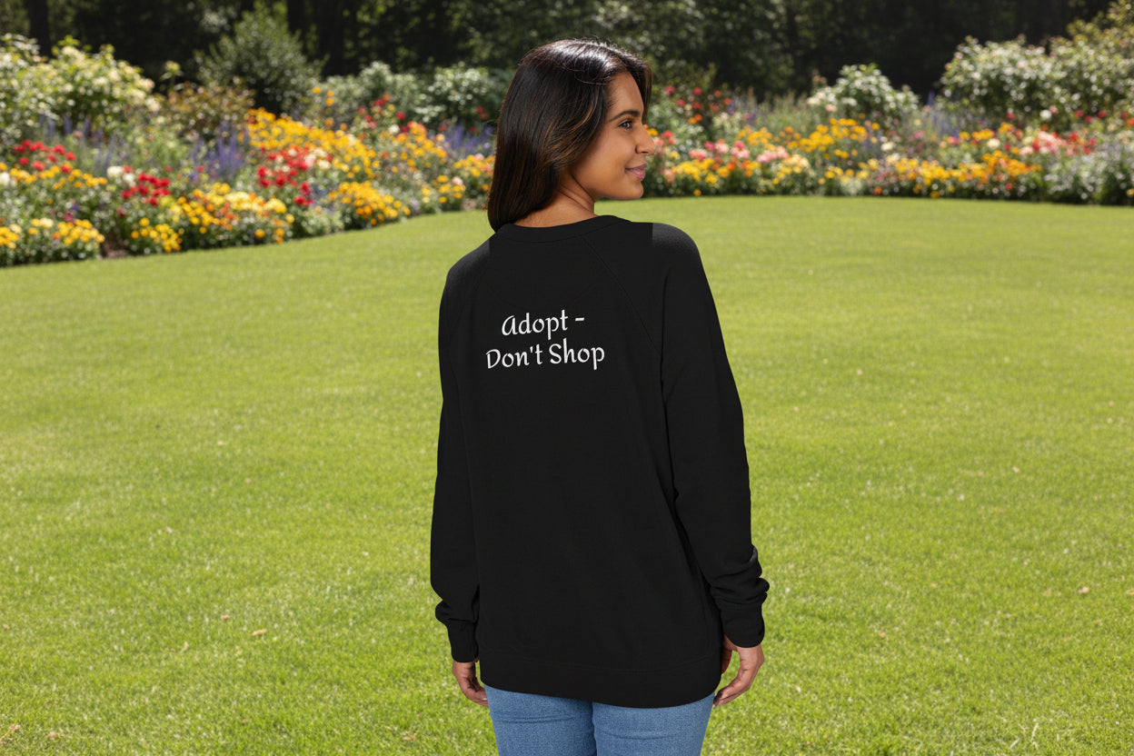 Person wearing a black raglan shirt with 'Adopt Don't Shop' text on the back.