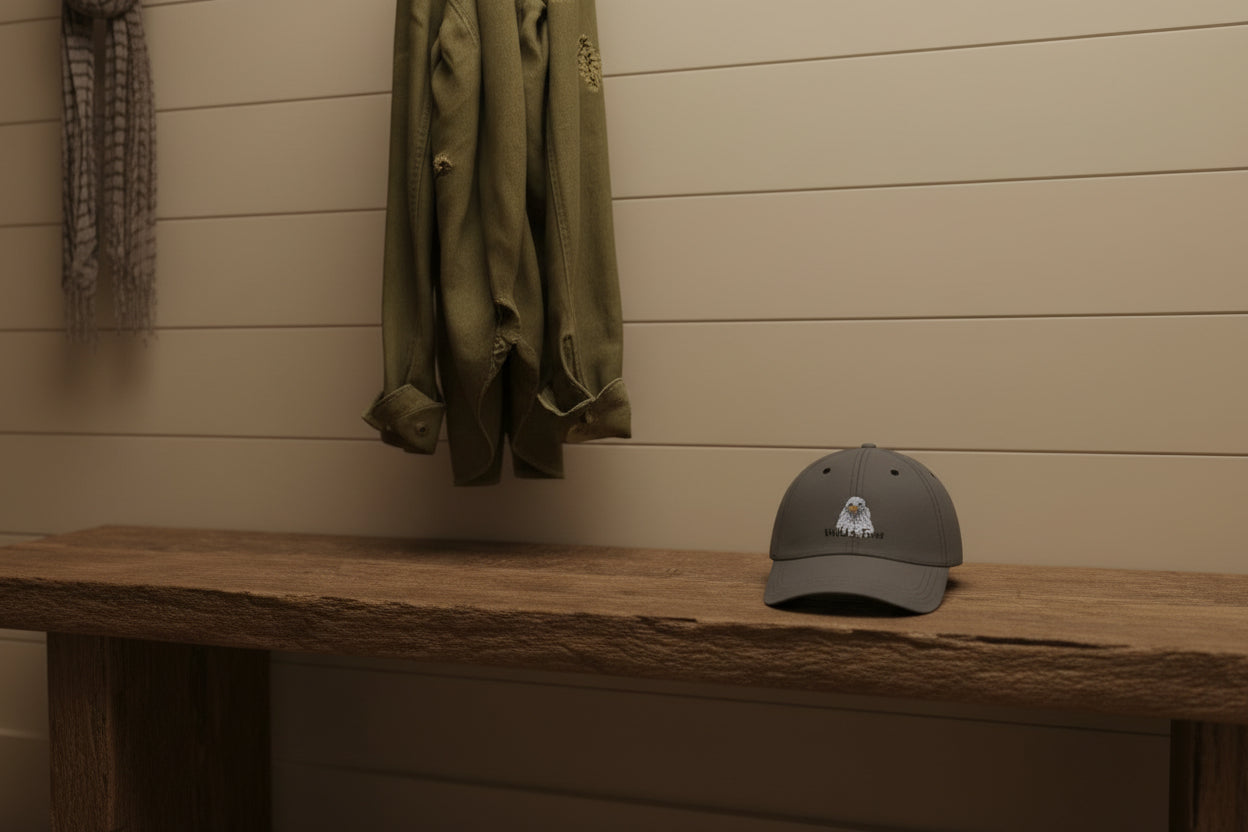Dark gray cap with an eagle design and 'Wild & Free' text on a green background