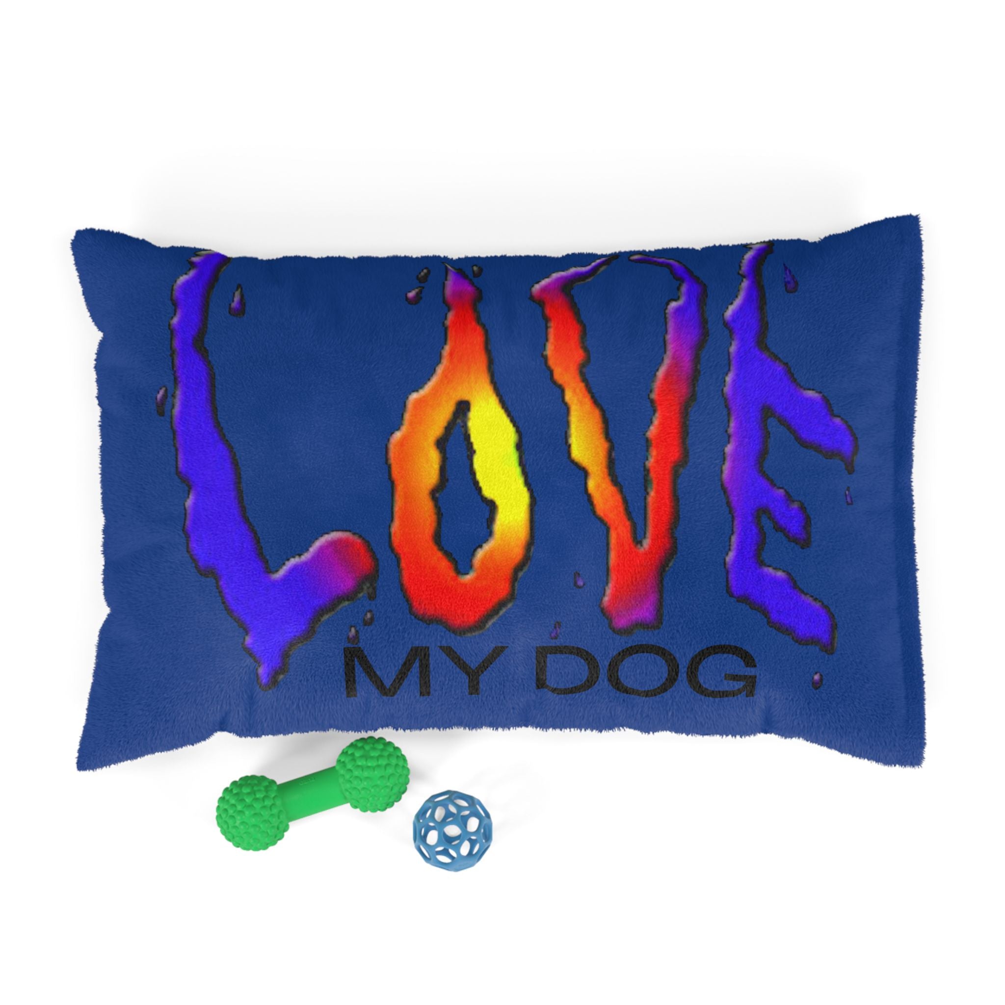 Blue pillow with colorful 'LOVE MY DOG' text and two dog toys on a white background