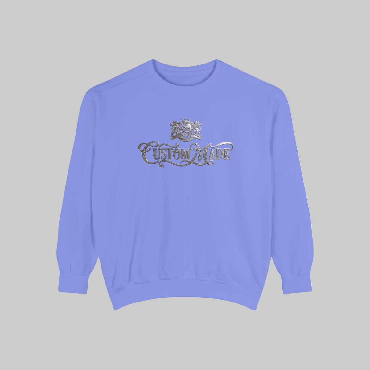 A light flo-blue crewneck sweatshirt with a metallic silver 'Custom Made' graphic and crest on the chest