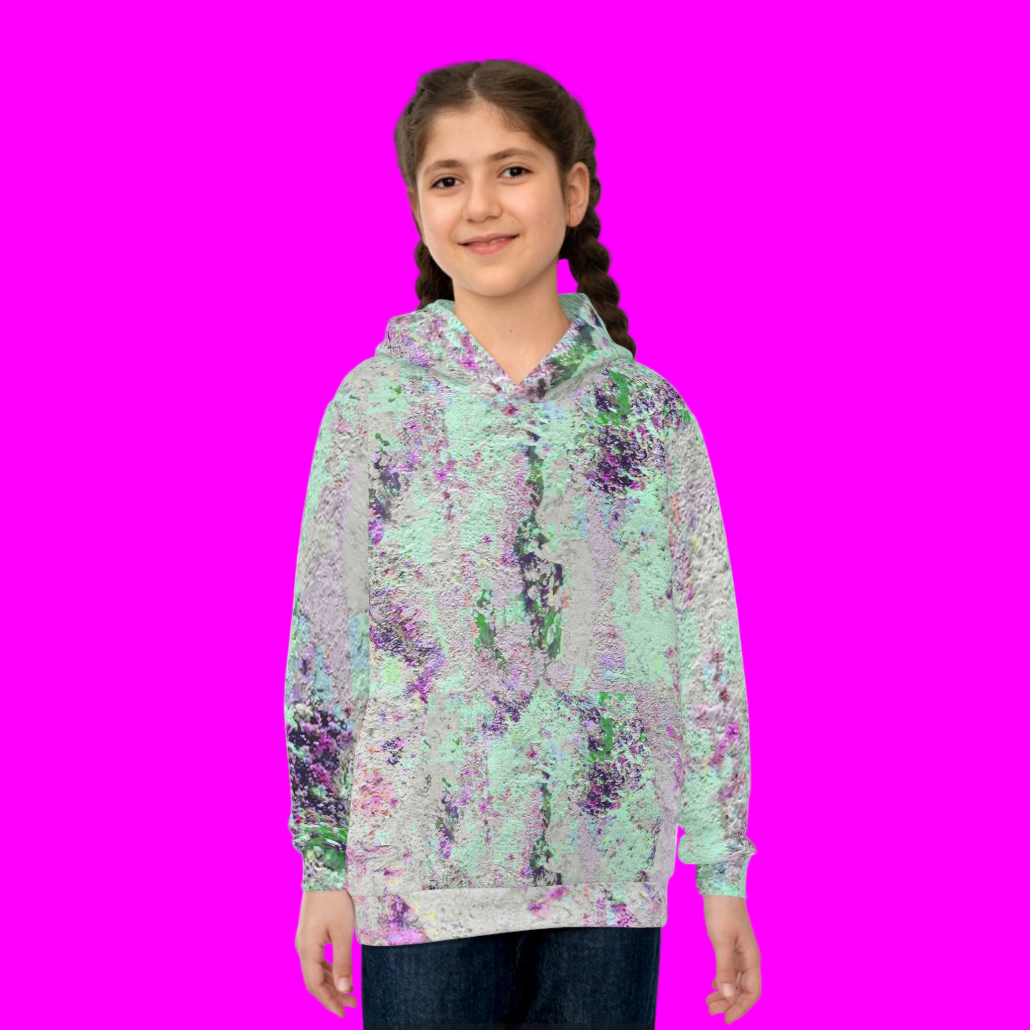 Girl wearing a abstract patterned hoodie on a pink background