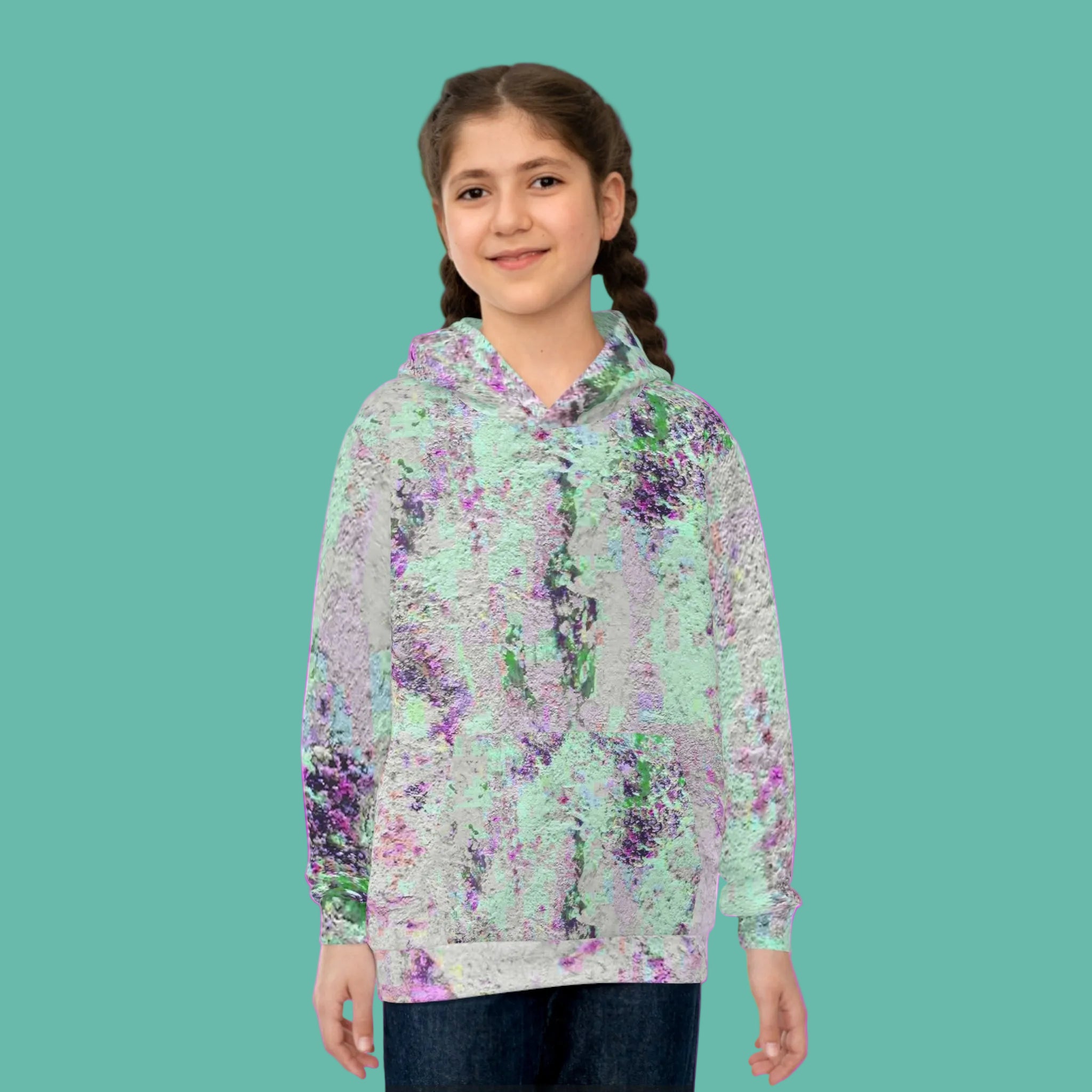 Girl wearing a abstract patterned hoodie on a pink background