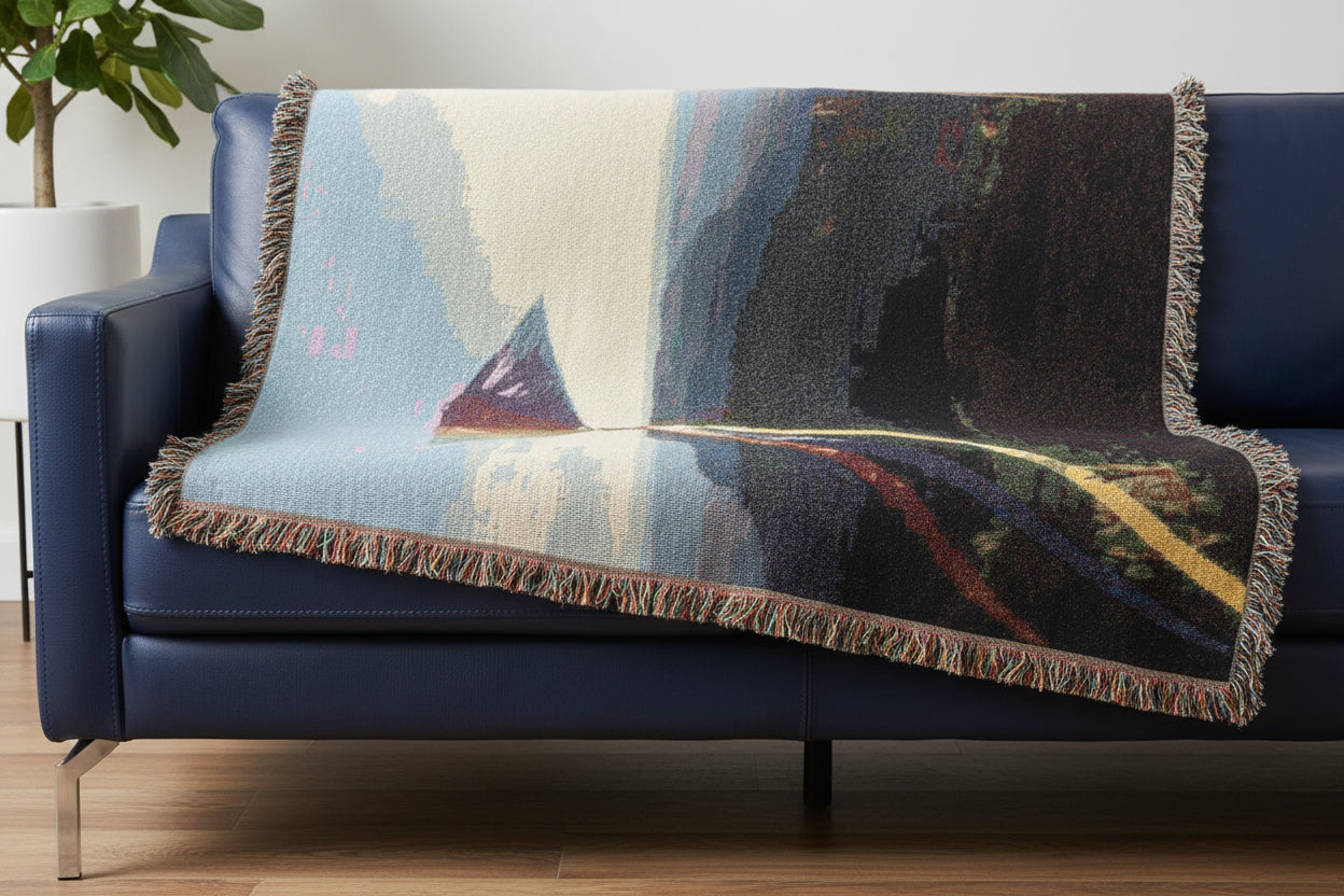 Woven throw blanket featuring a high flying kite over the mountains - against a blue sky.
