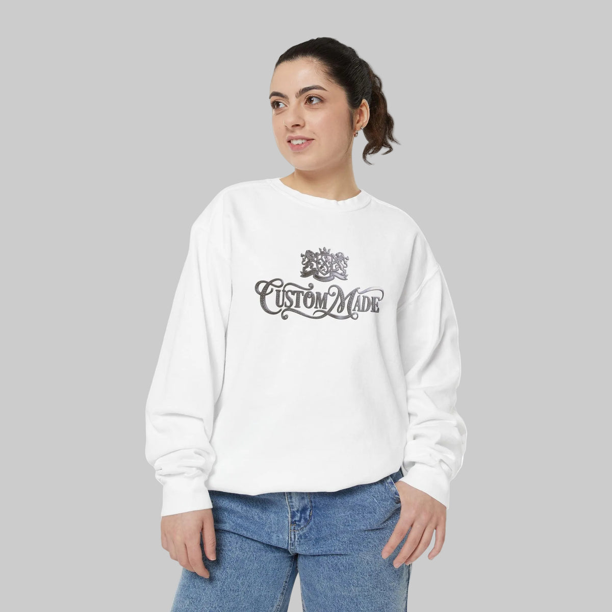 White crewneck sweatshirt with a Silver 'Custom Made' graphic on the chest