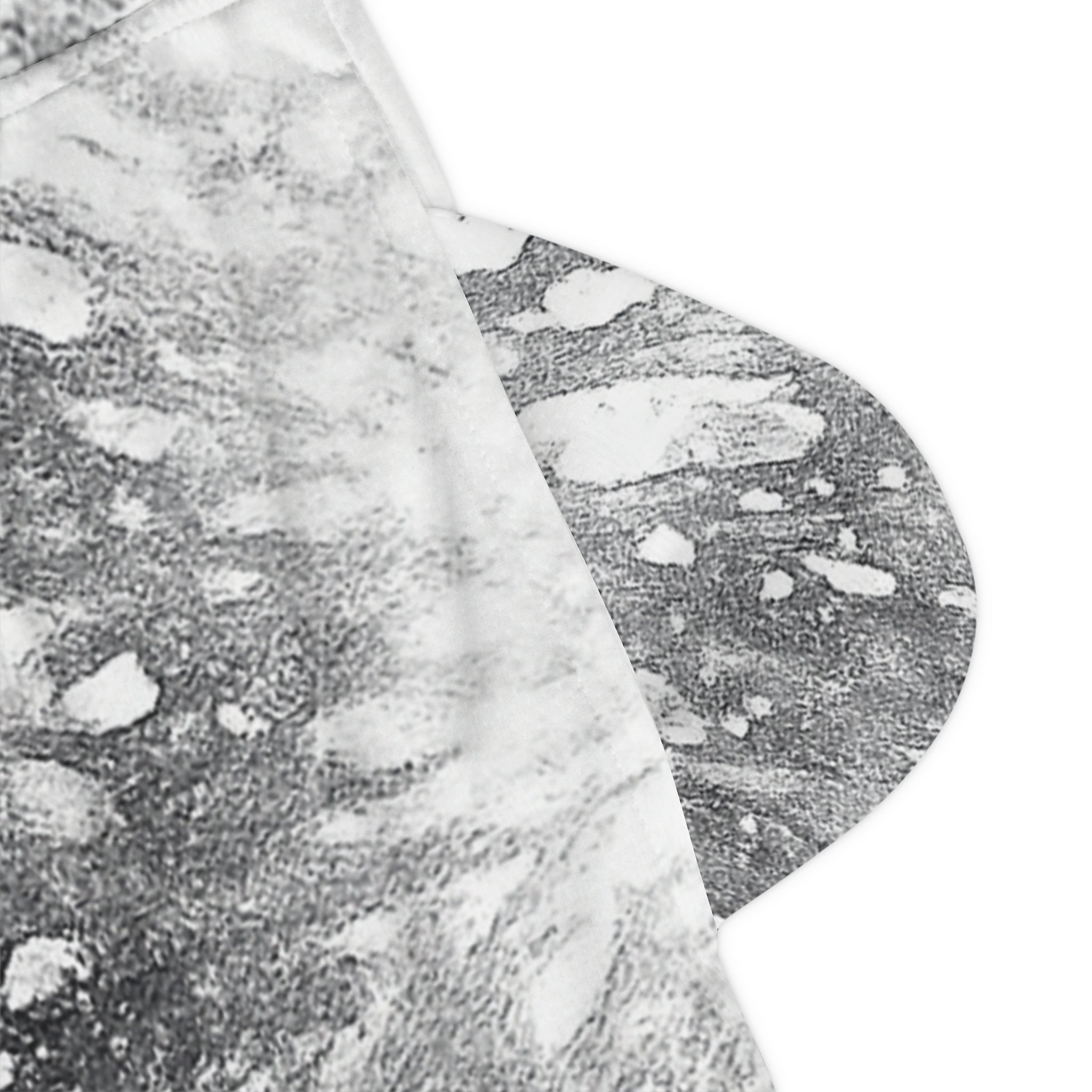 A close-up of a gray and white abstract patterned fabric on one of two pockets on low sides.