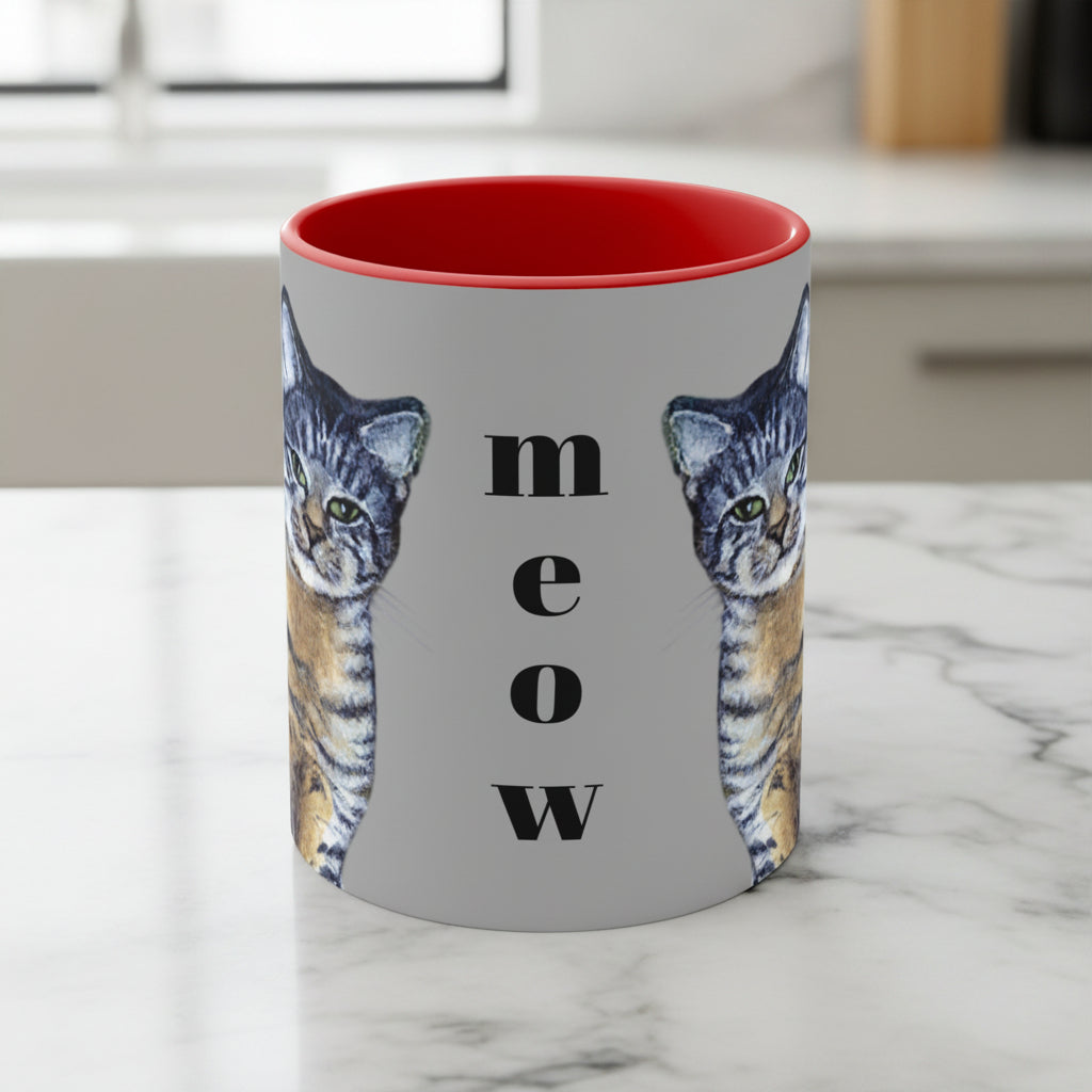 Mug with cat design and 'meow' text on a gray background with red interior and handle