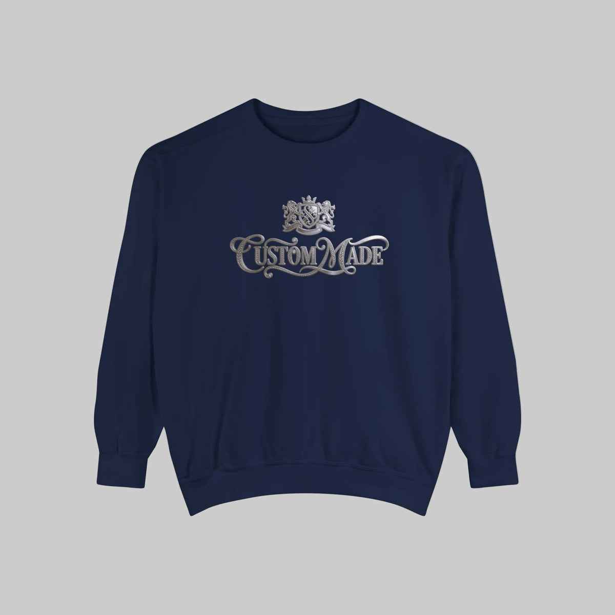 A navy blue crewneck sweatshirt with a silver graphic on the chest featuring a crest and the words 'Custom Made'