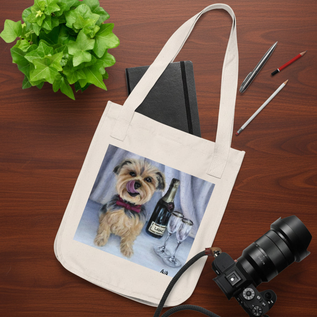 A beige canvas tote bag with a printed illustration of a small dog next to a wine bottle and glass