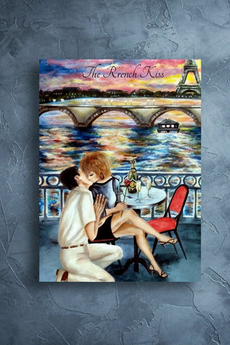 A vertical art print featuring an illustrated romantic Paris scene with two people kissing on a balcony overlooking the Seine, a bridge, and the Eiffel Tower at sunset. The print includes the text 'The French Kiss' at the top