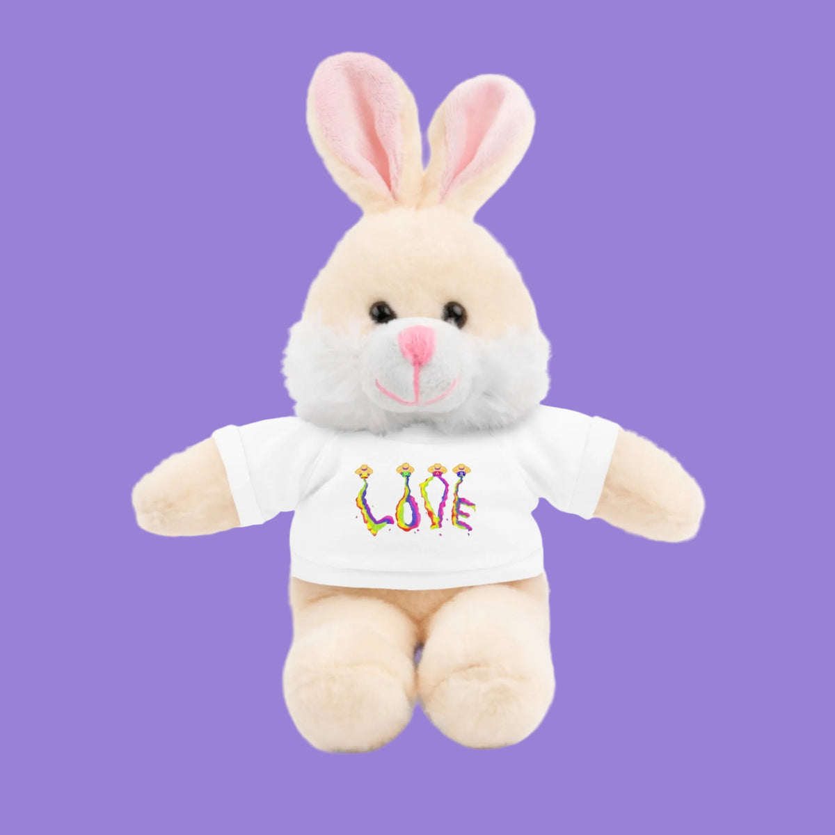 A plush bunny toy with light beige fur, pink inner ears, and a white t-shirt featuring the word 'LOVE' in colorful style letters