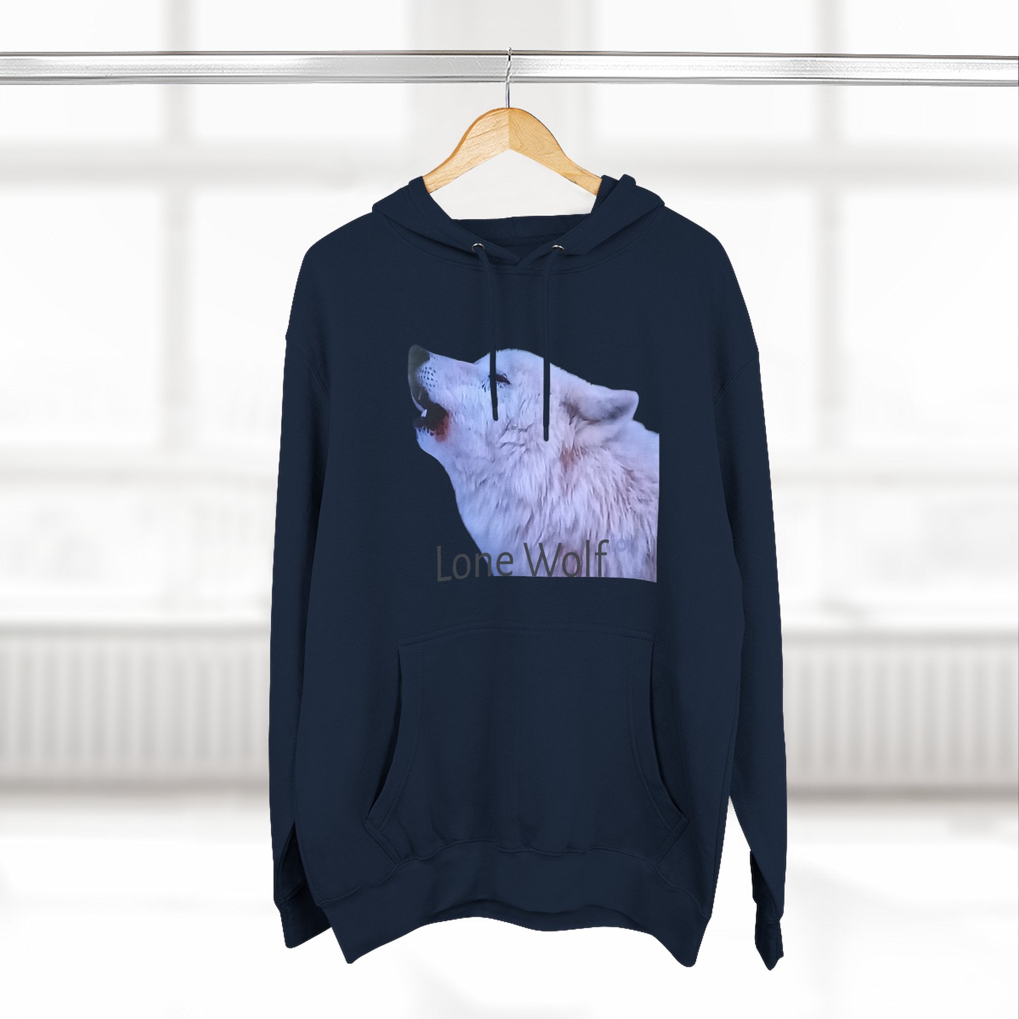 Navy blue hoodie with a wolf graphic and 'Lone Wolf' text on a hanger against a white wall.