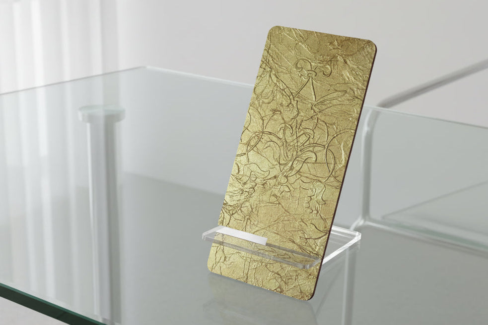 Gold phone stand with intricate scrollwork design