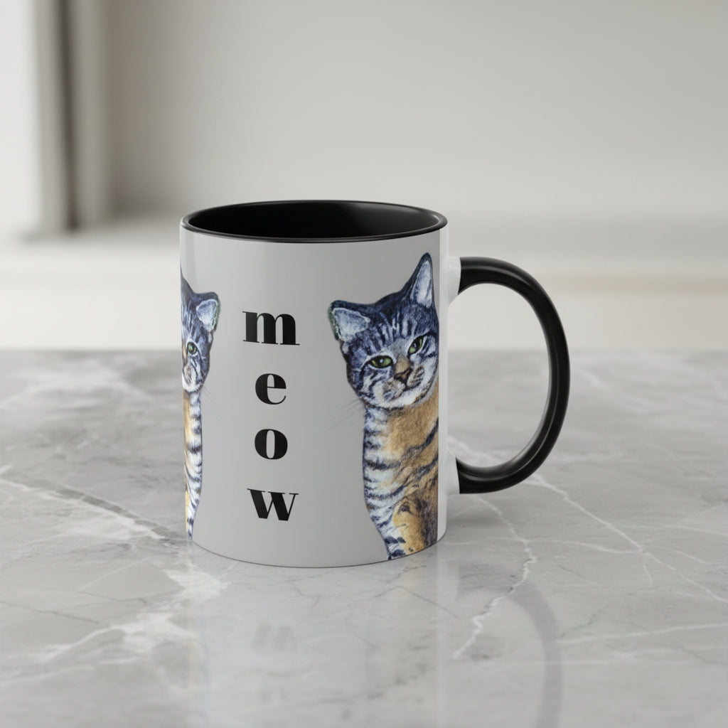 Mug with cat design and 'meow' text on a gray background with black interior and handle