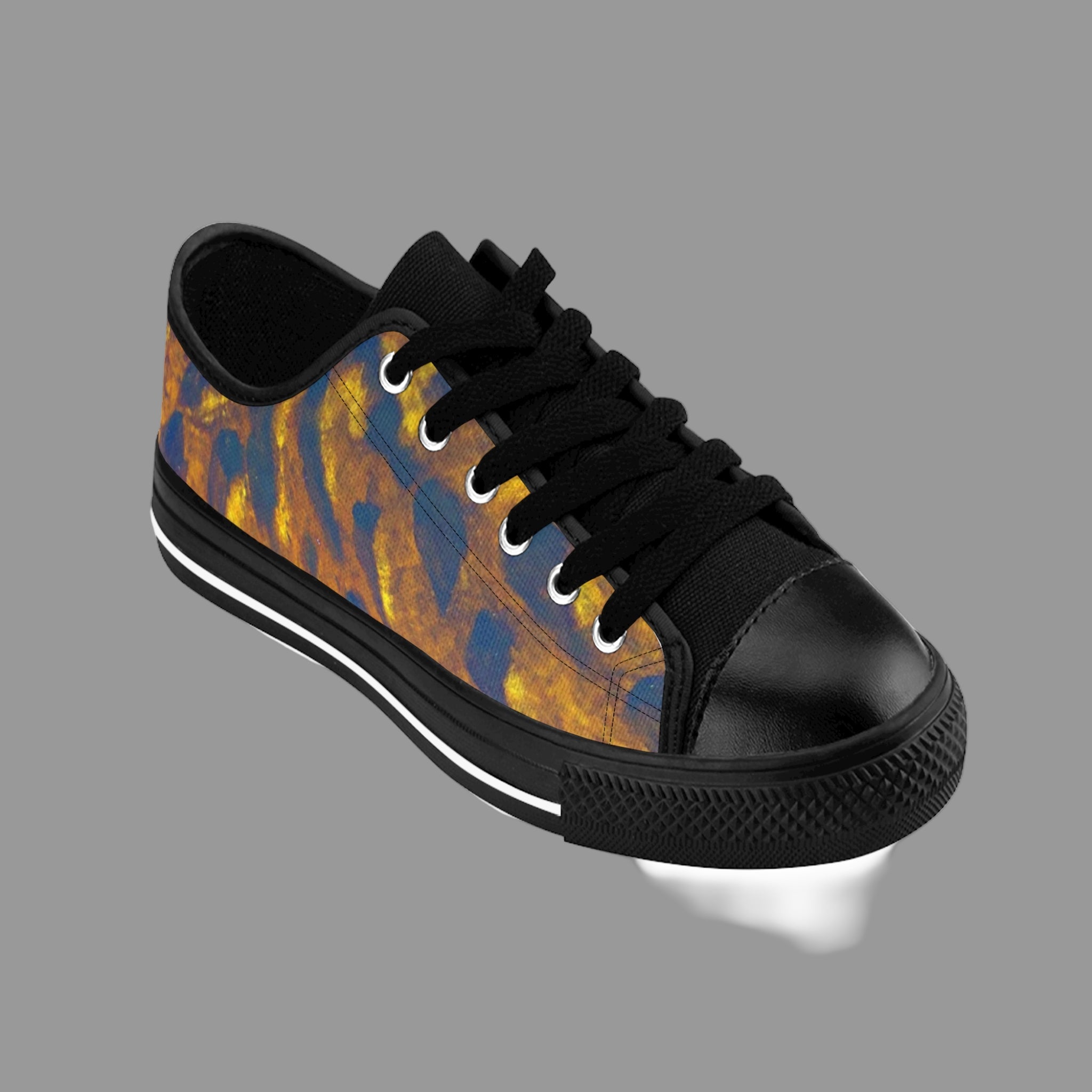 Black sneaker with a colorful pattern on a light background