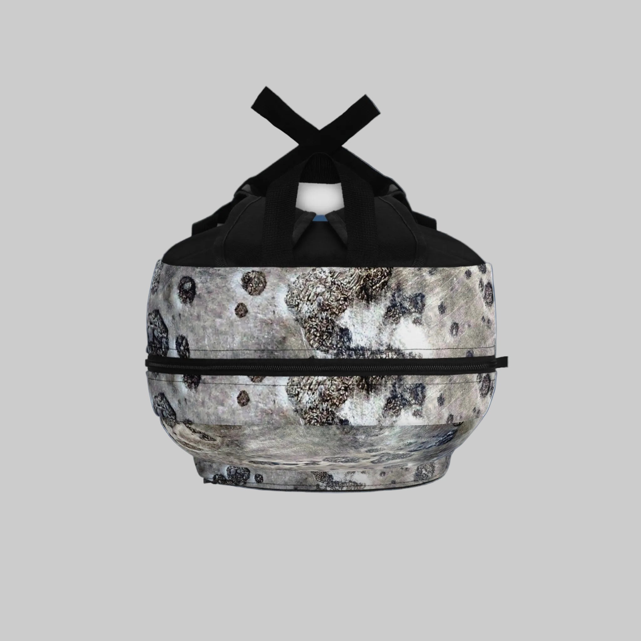 Top of backpack with black straps on a blue background