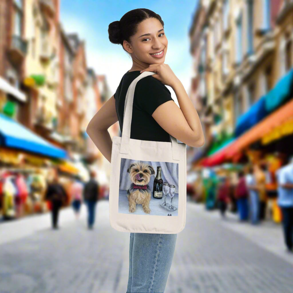 Woman holding a tote bag with an adorable Yorkie illustration - roomy and tough 100% organic cotton canvas