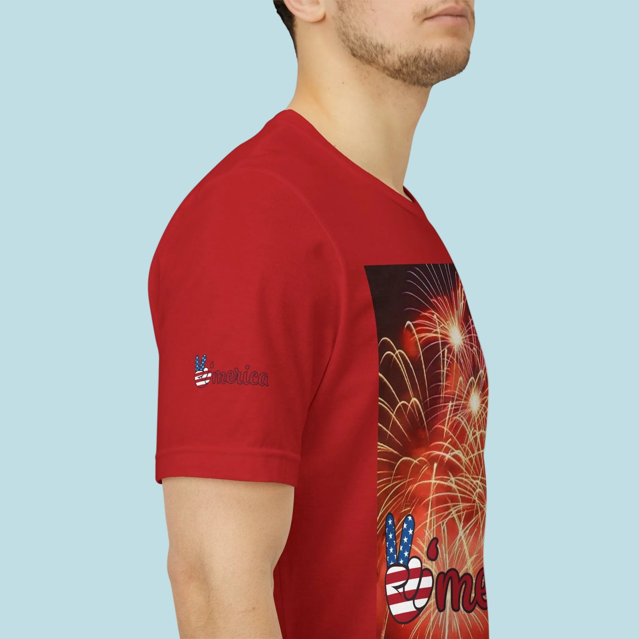 Red t-shirt with a graphic design on the back, featuring fireworks and a peace symbol and image on sleeves