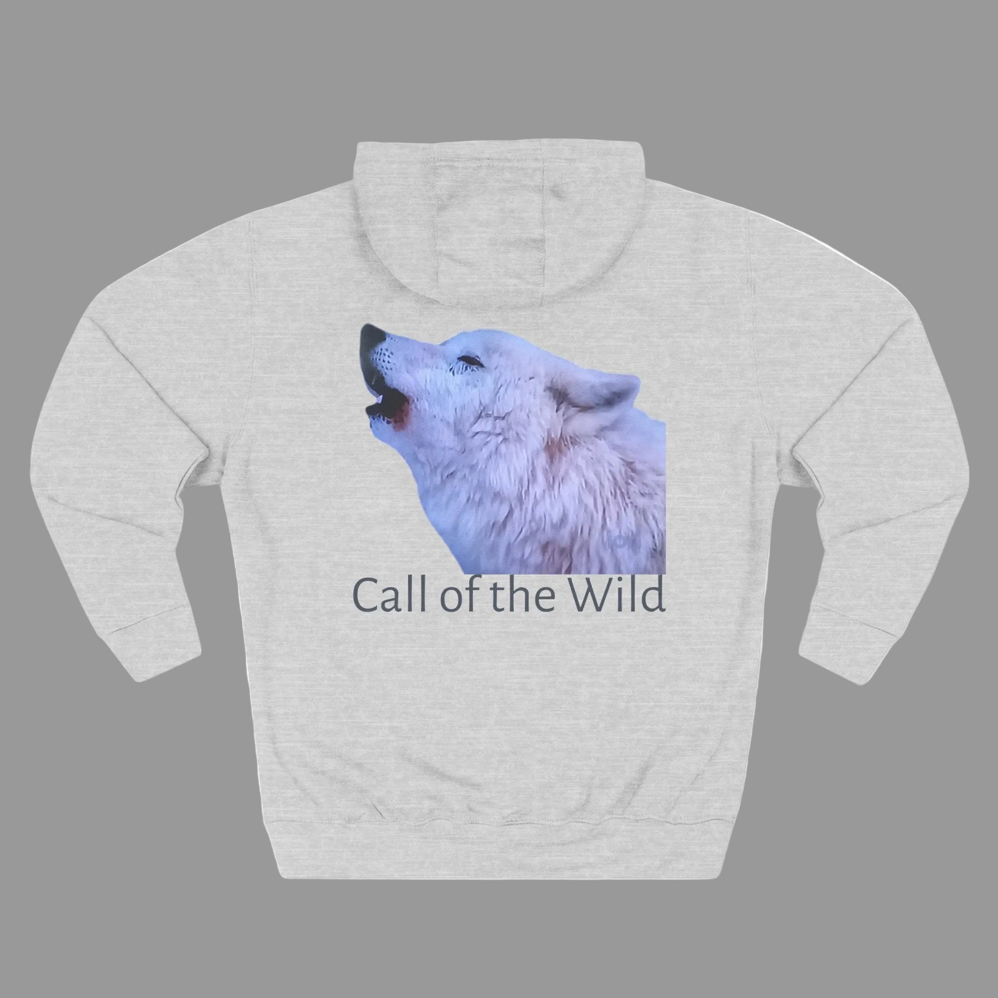 A light heather gray pullover hoodie featuring a graphic print of a white wolf howling, with the text 'Call of the Wild' printed underneath XS-3XL
