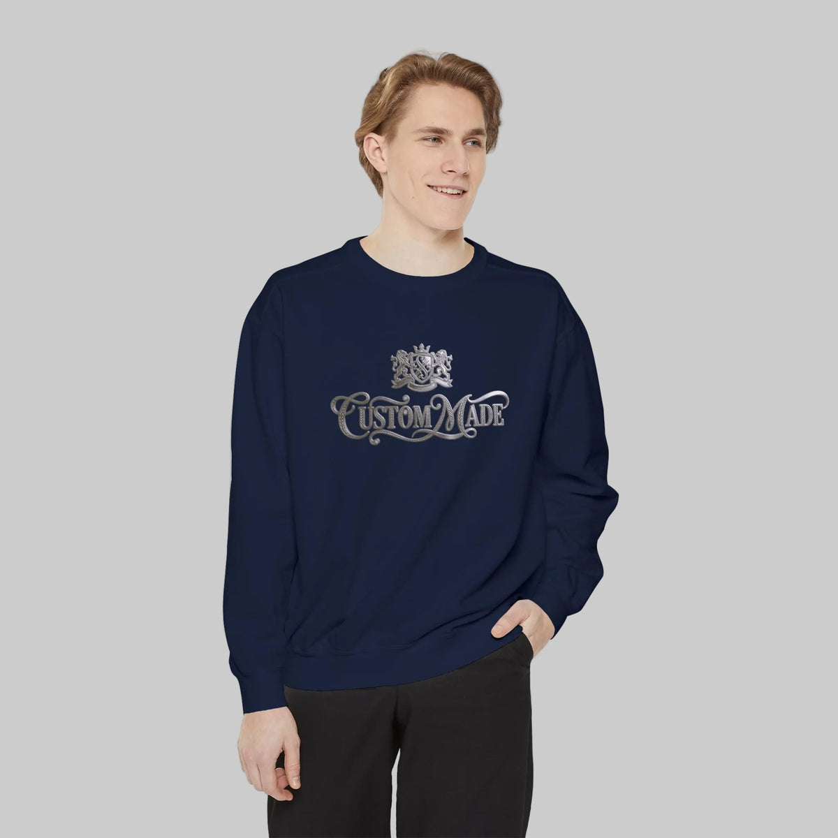 Person wearing a navy blue sweatshirt with 'CUSTOM MADE' and Crest in silver