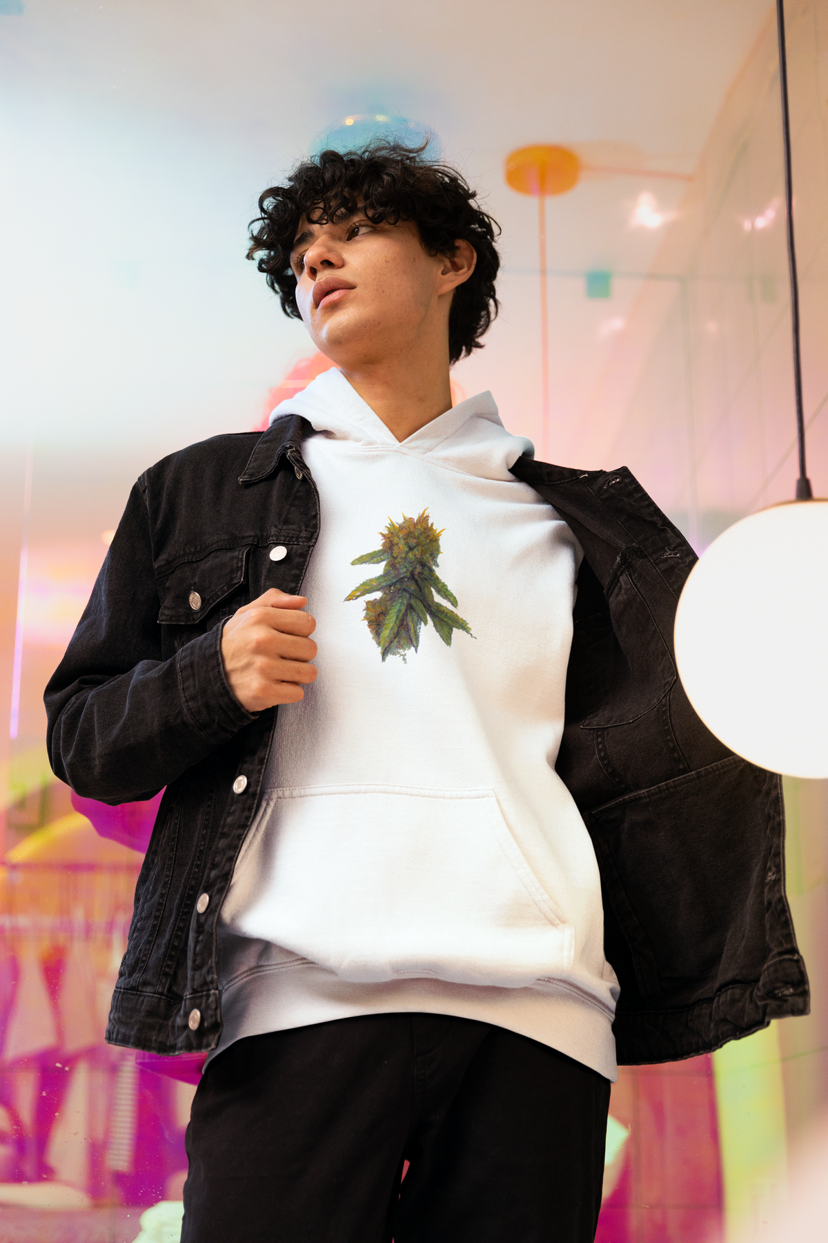 Unisex white pullover hoodie with a green and yellow cannabis leaf graphic on the chest with a roomy kangaroo front pocket