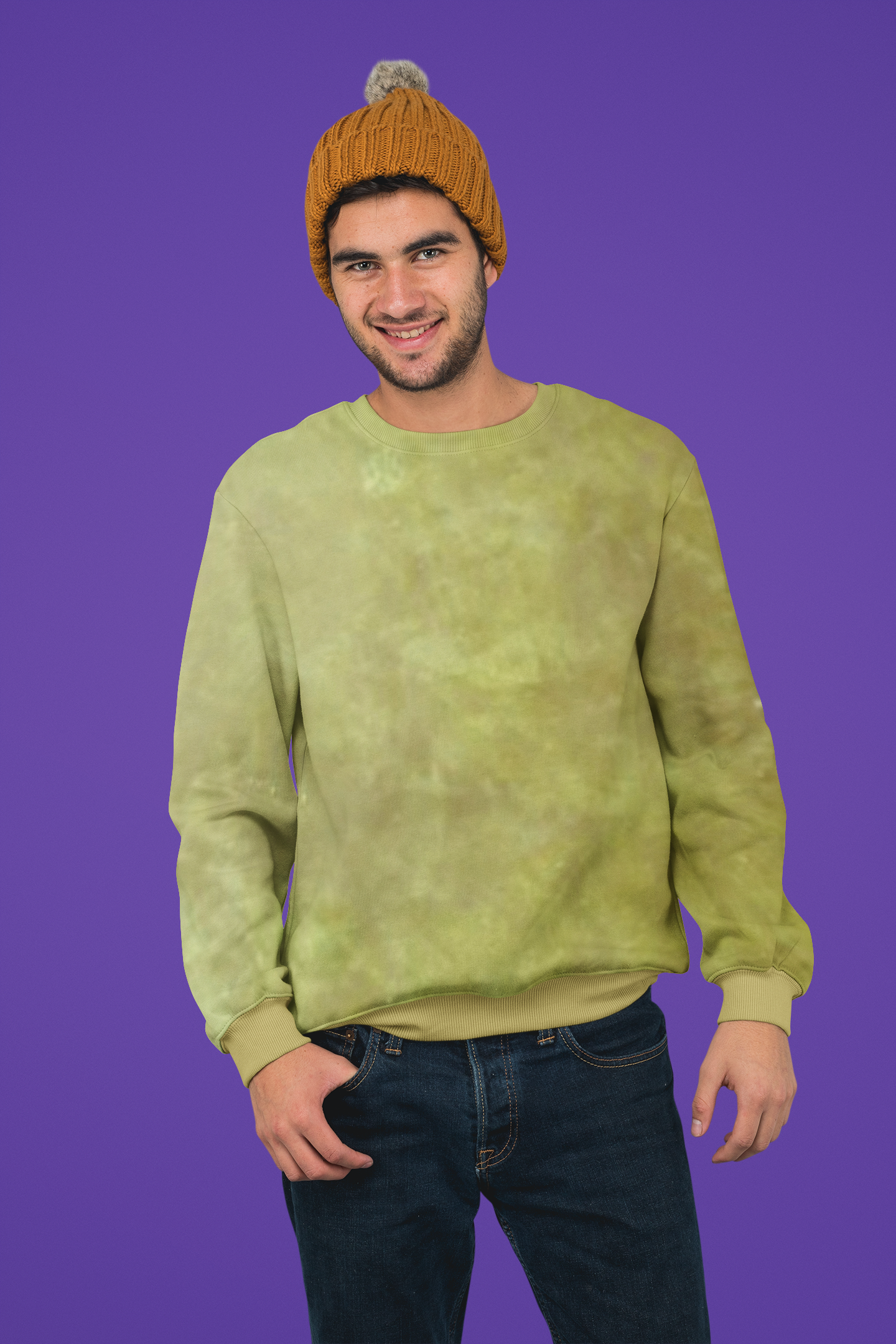 Man wearing a green tie-dye sweatshirt and orange beanie against a purple background