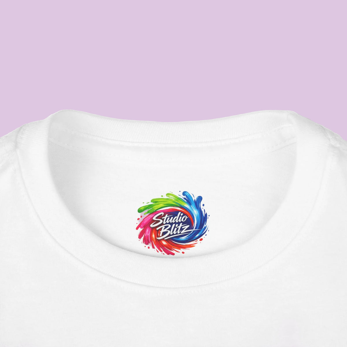 Close-up of a white crew-neck t-shirt featuring a colorful 'Studio Blitz' logo printed on the inside of the collar.