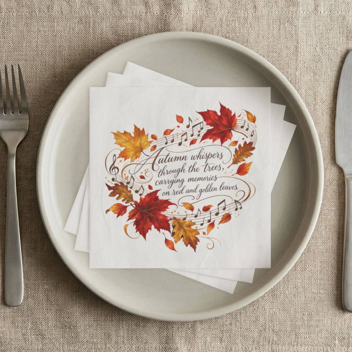A stack of white paper napkins printed with autumn leaves and elegant script text of Fall message.