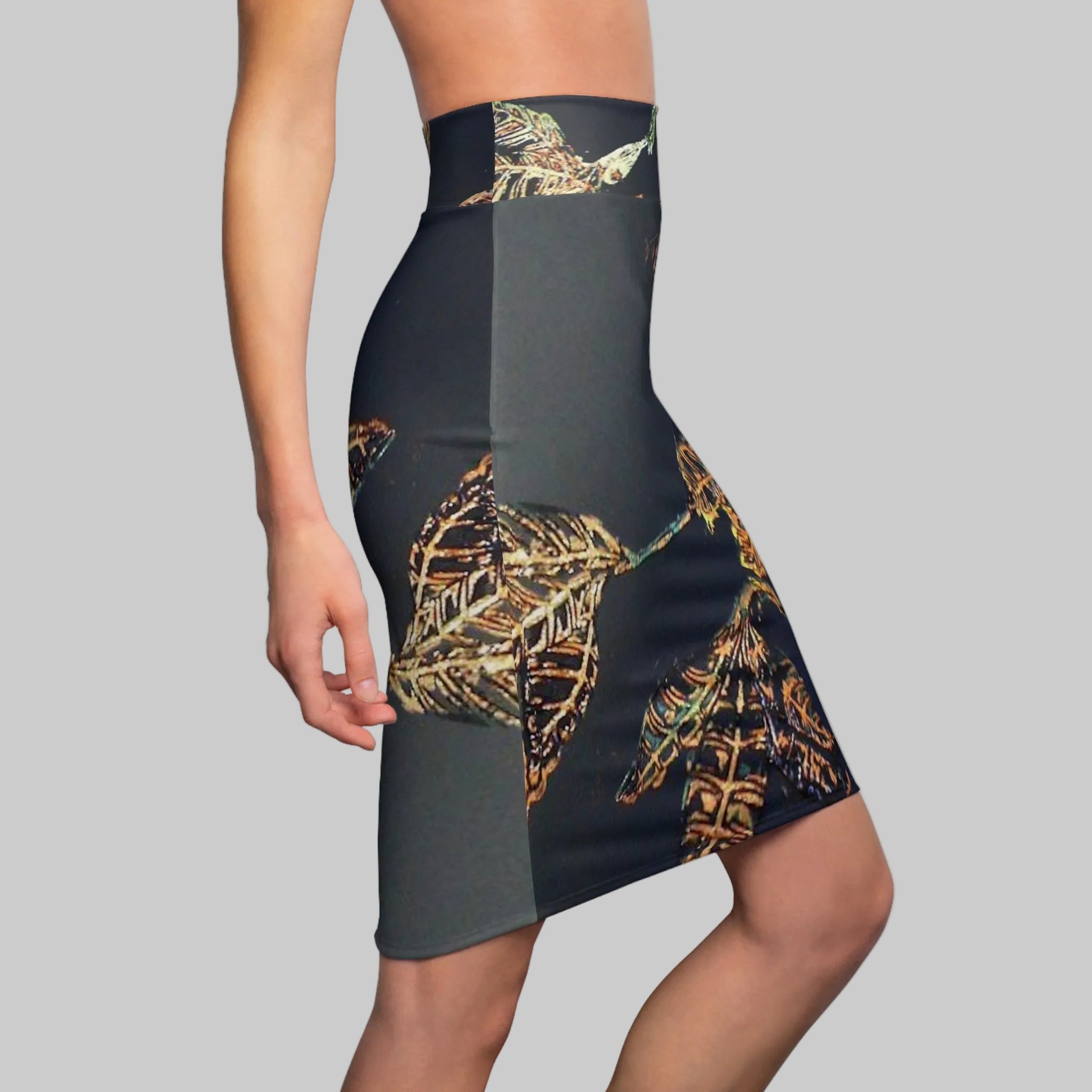 High-waisted pencil skirt with a color-blocked design featuring a tropical leaf print in gold, brown, and green. 95% Polyester 5% spandex