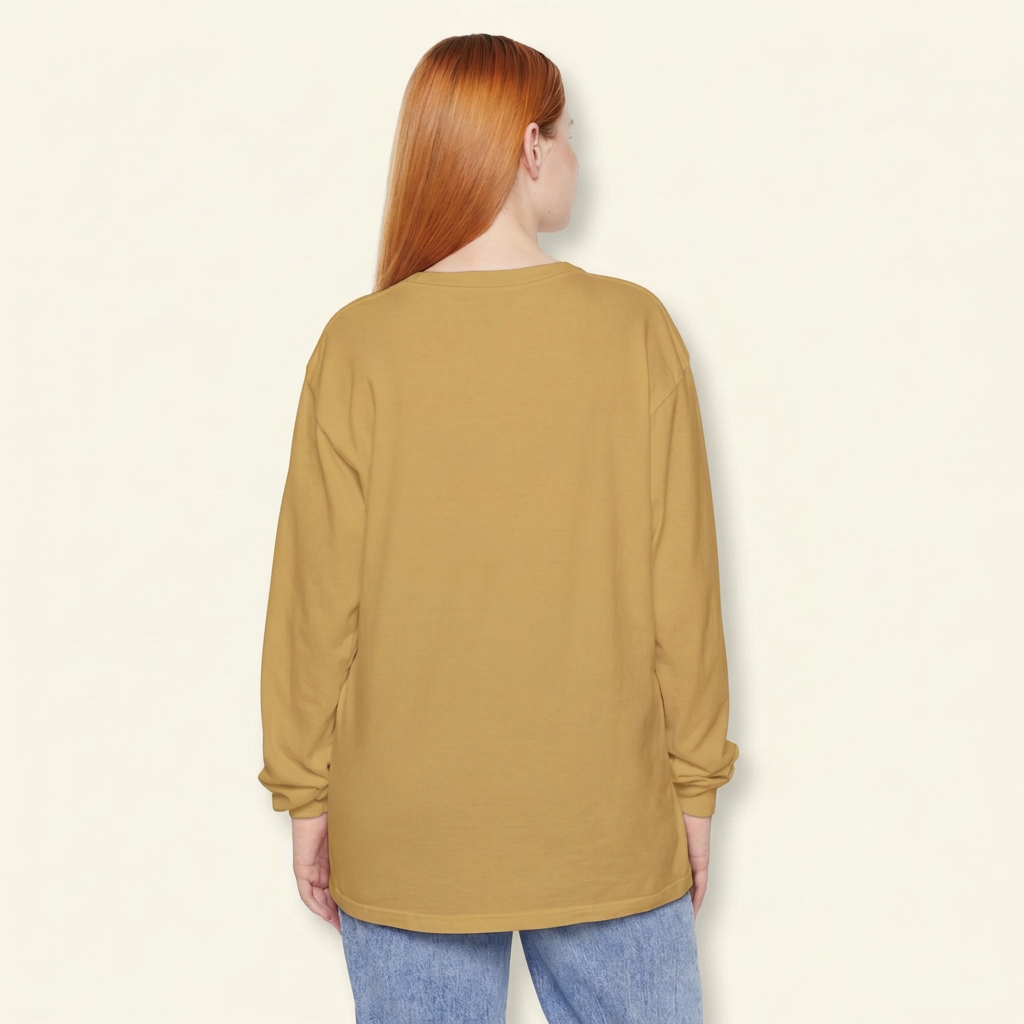 Back view of a red-haired woman wearing a plain mustard gold long-sleeve tee and blue jeans.