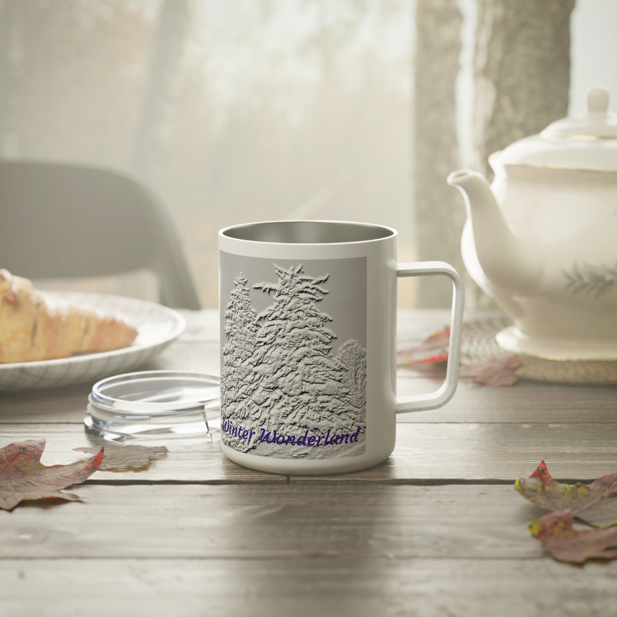 White mug with textured like tree design and 'Winter Wonderland' text in blue in stainless steel construction and top