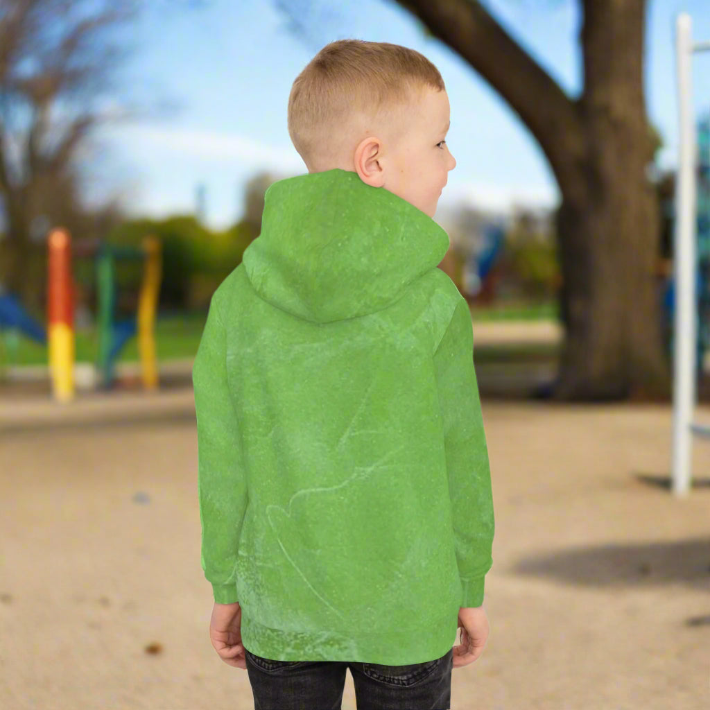 Child wearing a green hoodie in a park