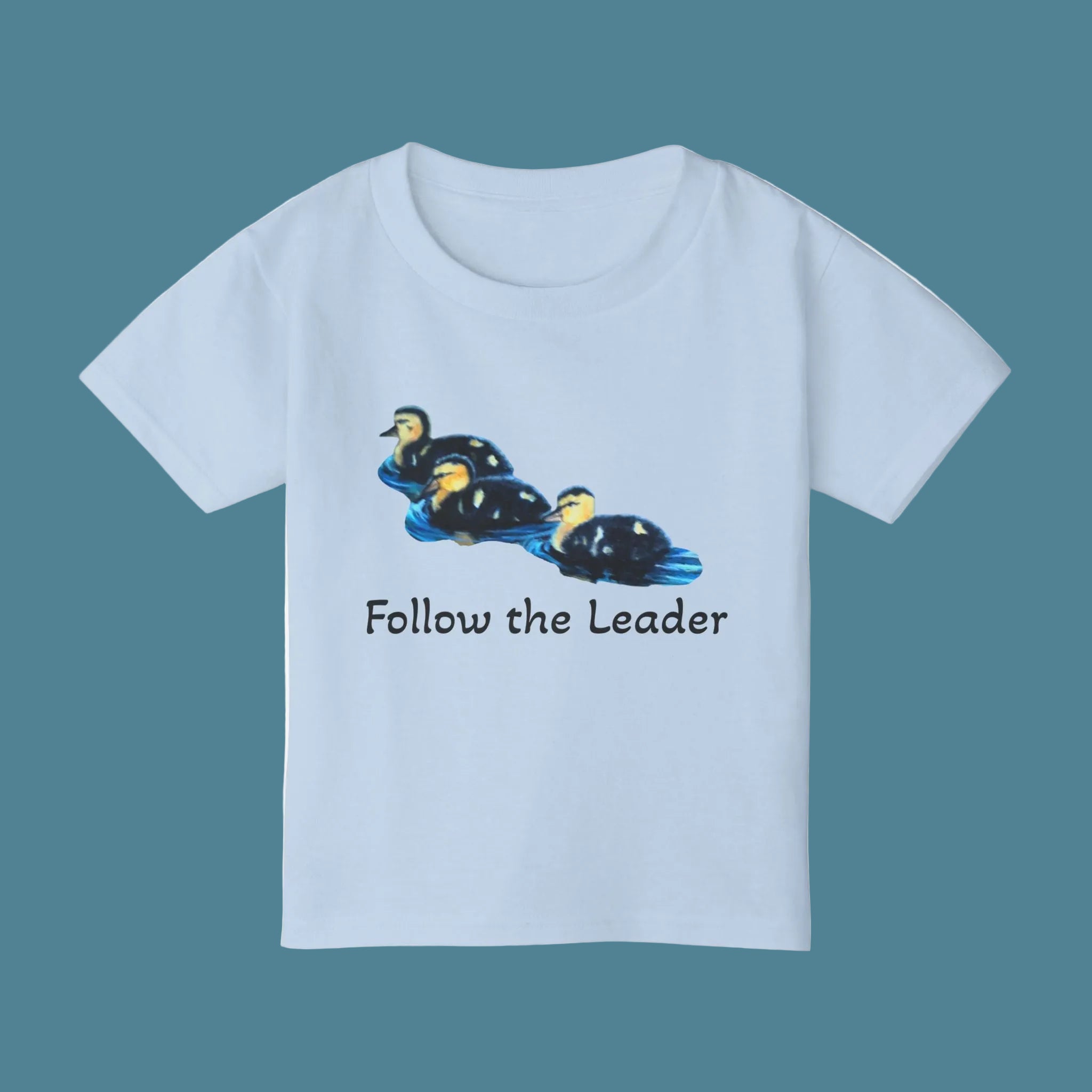 Light blue child's t-shirt with duck graphic and 'Follow the Leader' text on front and 'Are we there yet' on the back