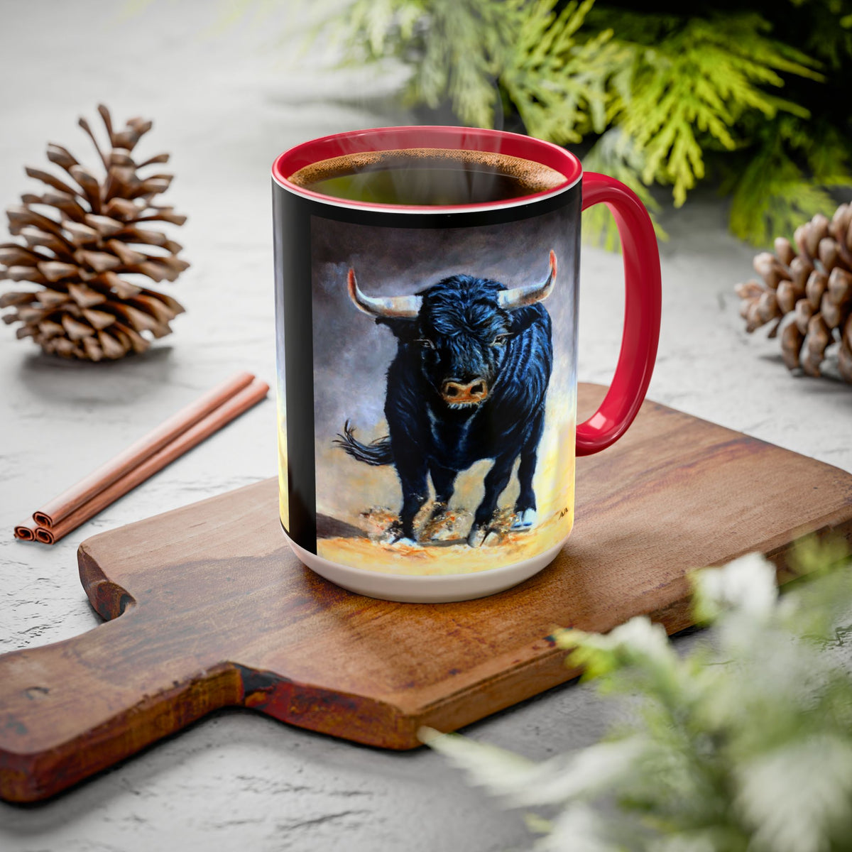 A ceramic coffee mug with a red handle and interior, featuring a painted illustration of a black charging bull 15 oz.