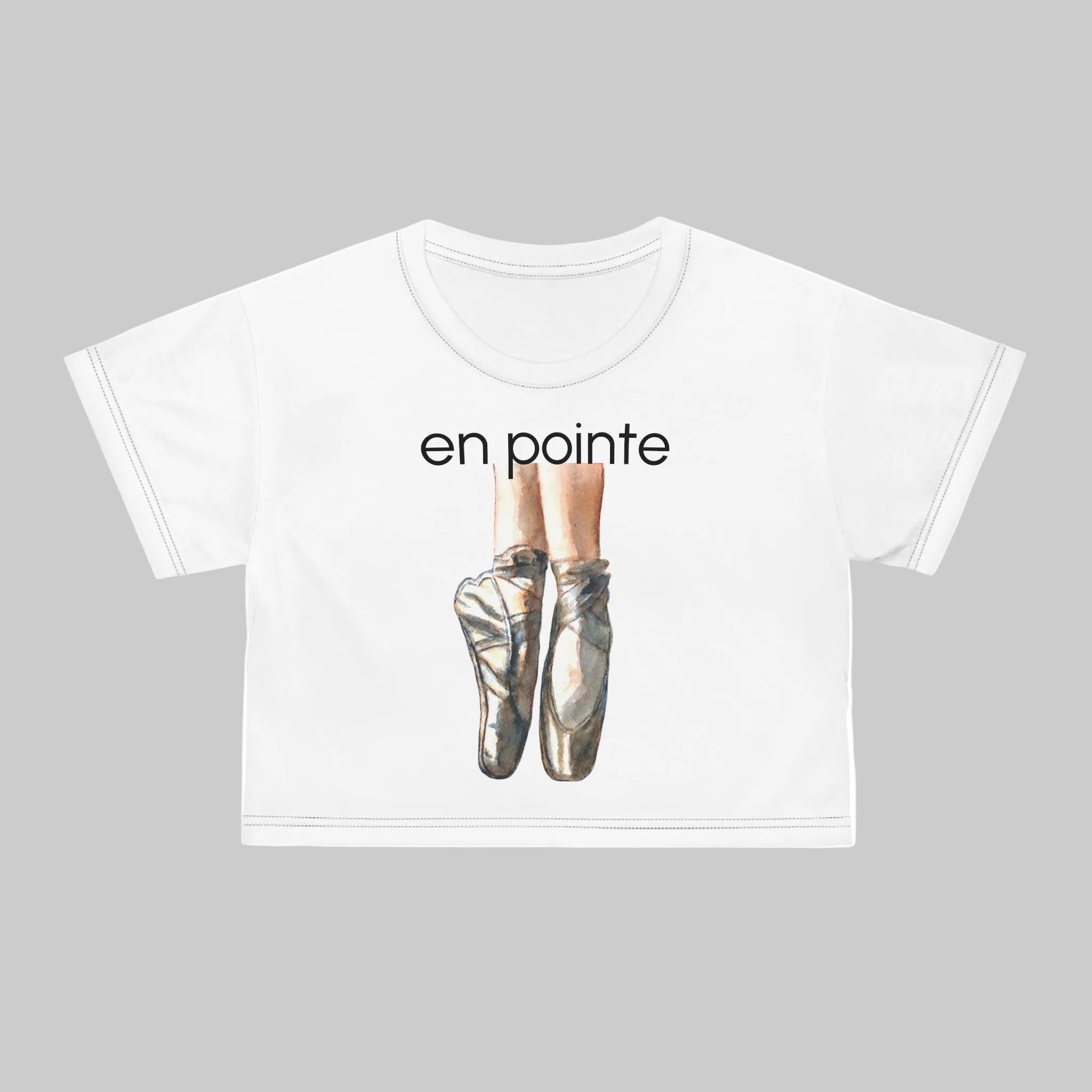 White short-sleeve crop tee featuring  pointe shoes with the text 'en pointe'.  This Tee shows seams in Black Thread. White thread also available. 