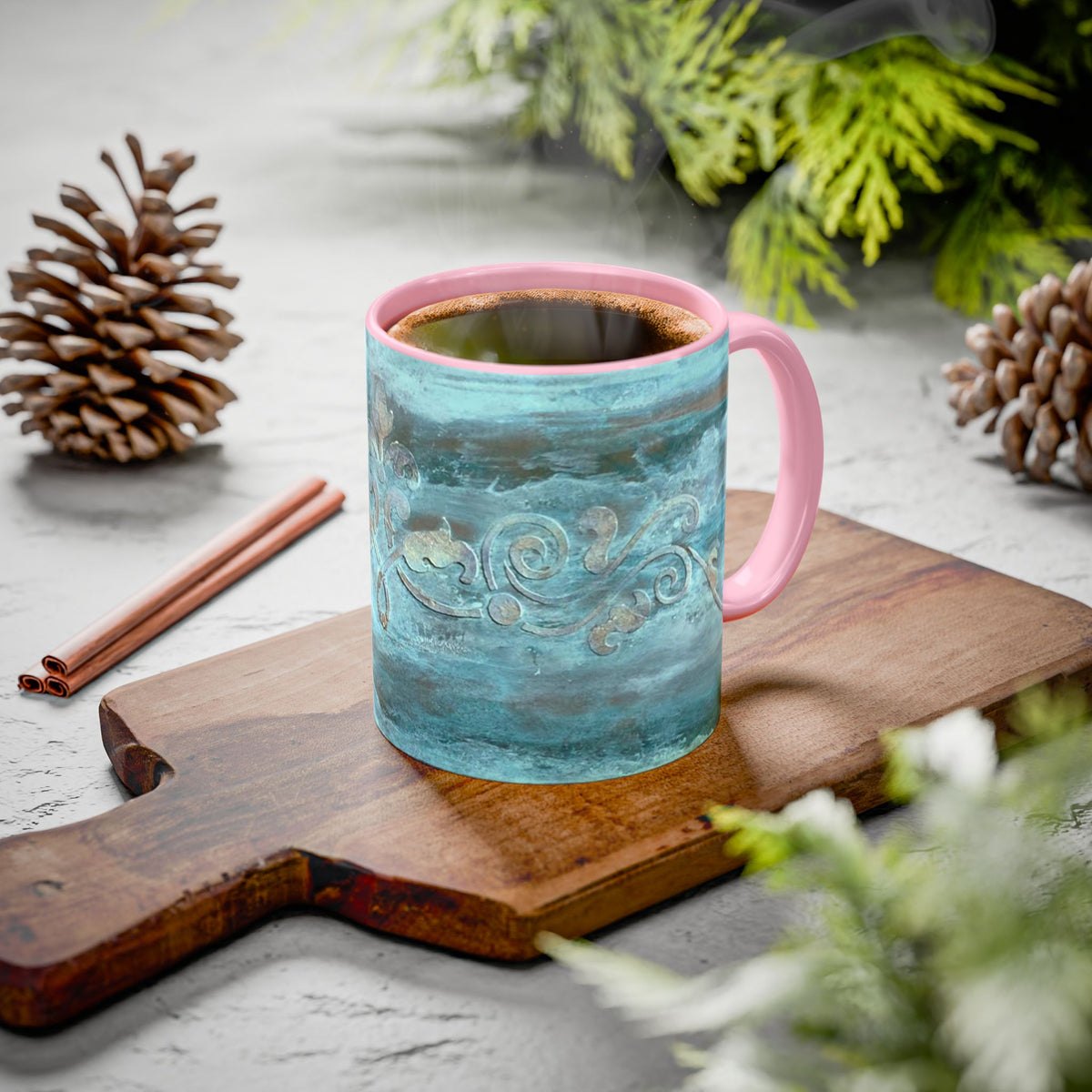 Turquoise 11 oz mug with scrolled art work and pink C Handle and interior