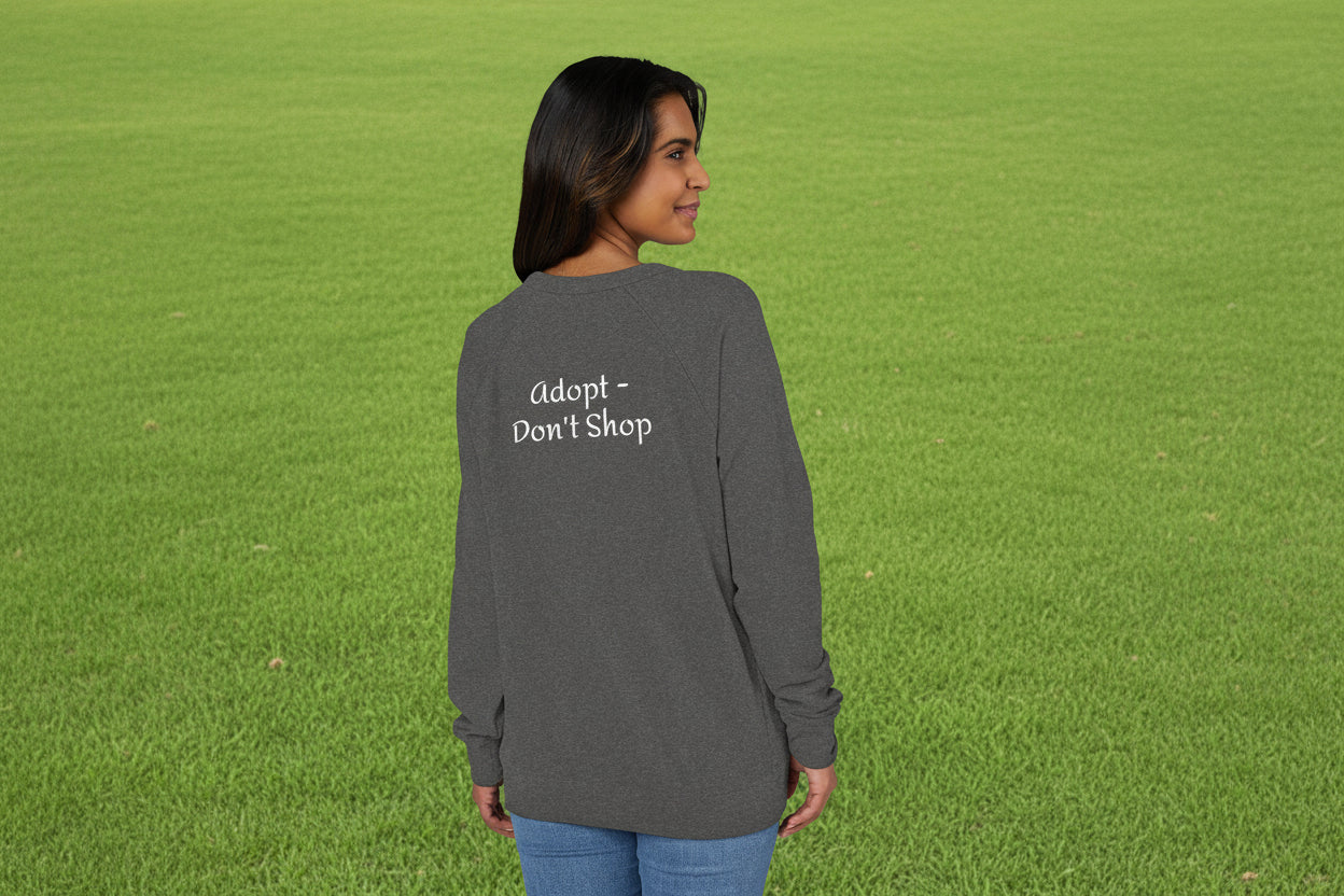 Person wearing a grey raglan shirt with 'adopt don't shop' text on the back
