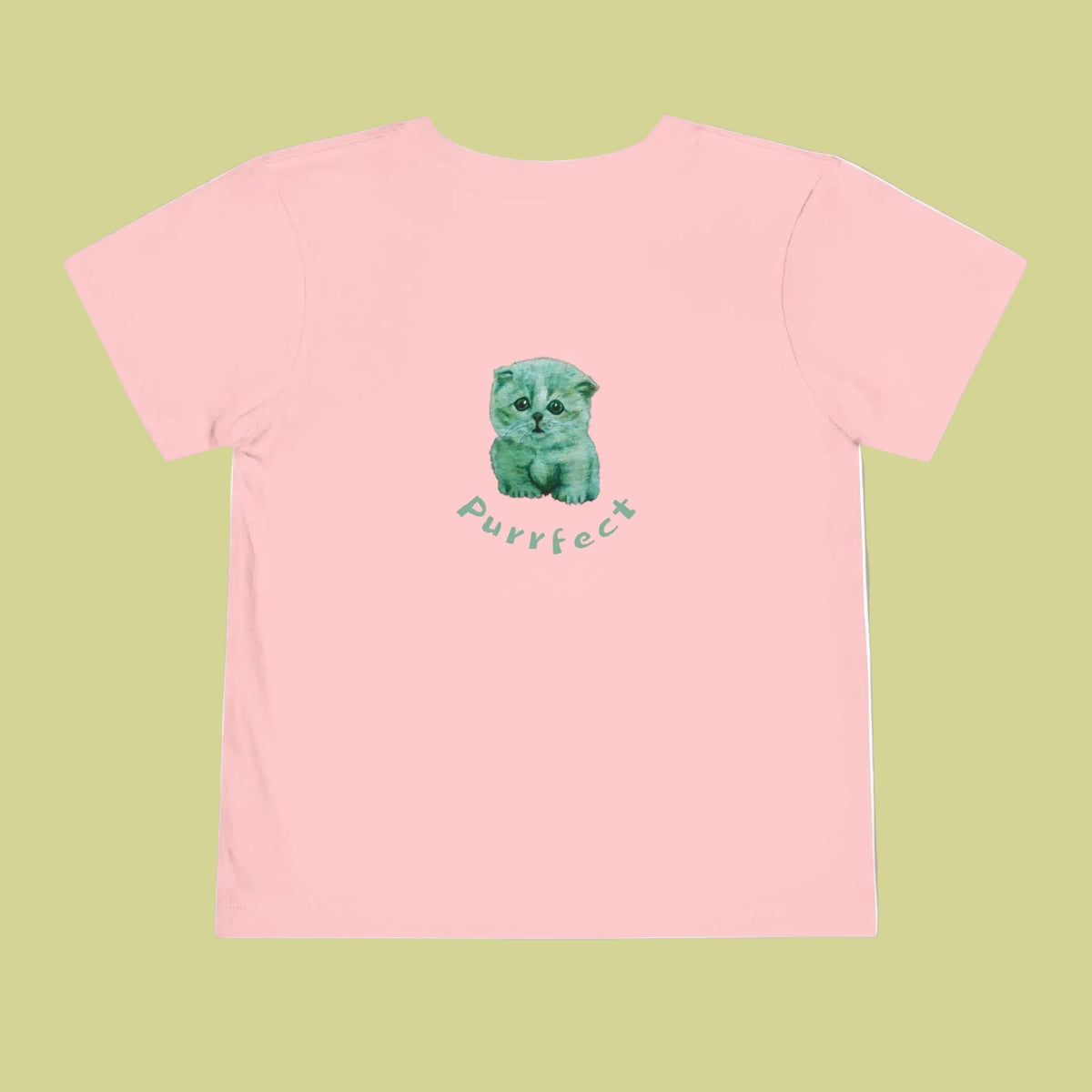 A light pink short-sleeve t-shirt with a central graphic of a cute greenish-blue kitten sitting above the word 'purrfect' in a matching teal script