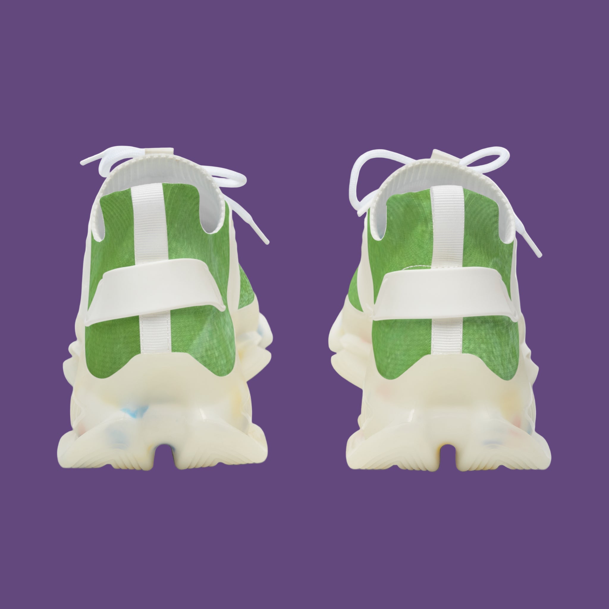 Green and white backs of men sneakers on a purple background