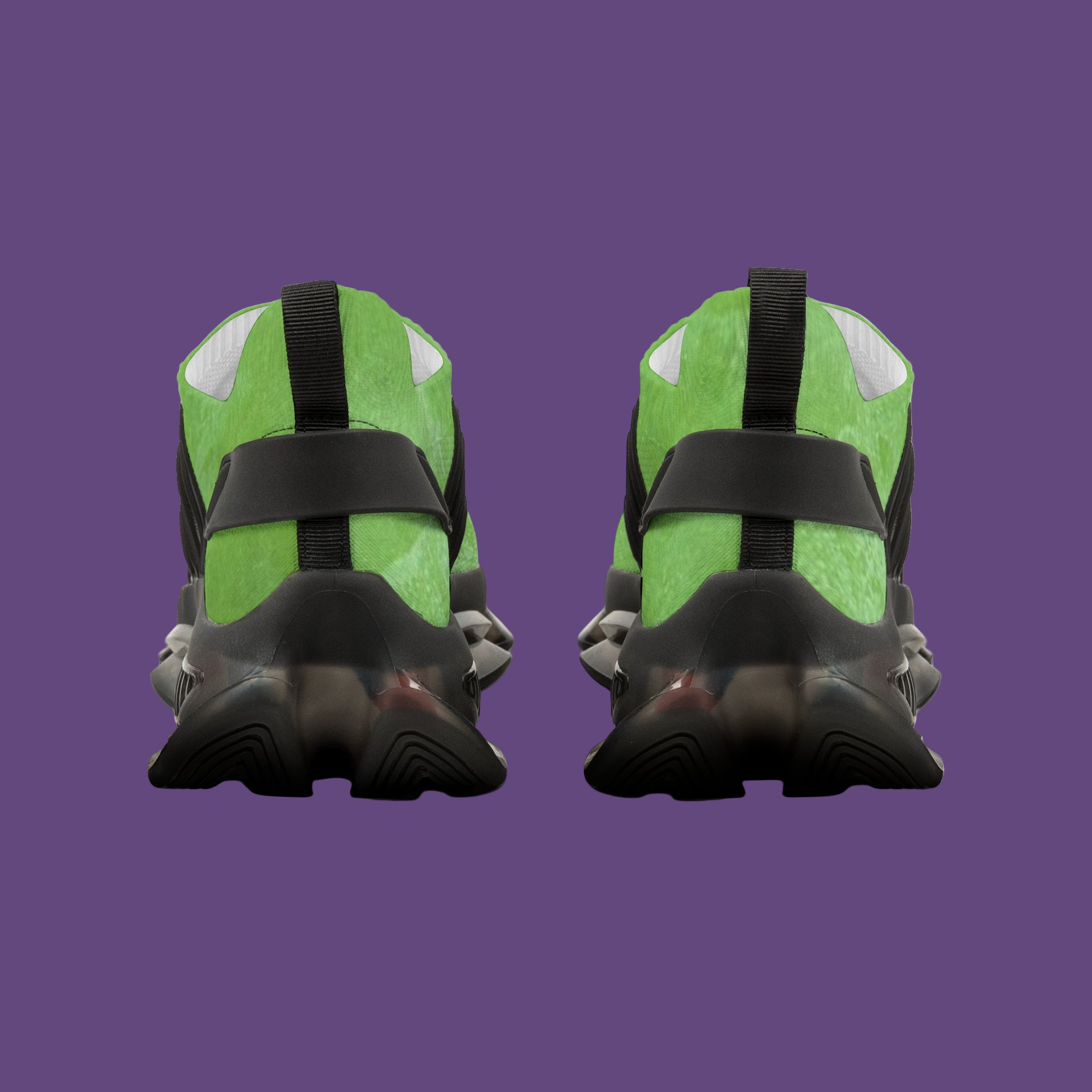 Green and black athletic shoes with unique sole design on a purple background