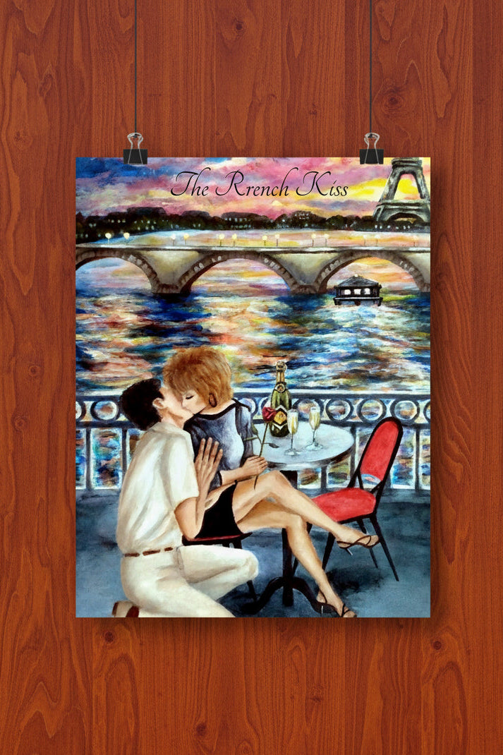 A vertical art print or poster showing a romantic Paris scene with two people kissing on a balcony overlooking a bridge and river, with the Eiffel Tower in the background. The print includes the text 'The French Kiss' at the top.