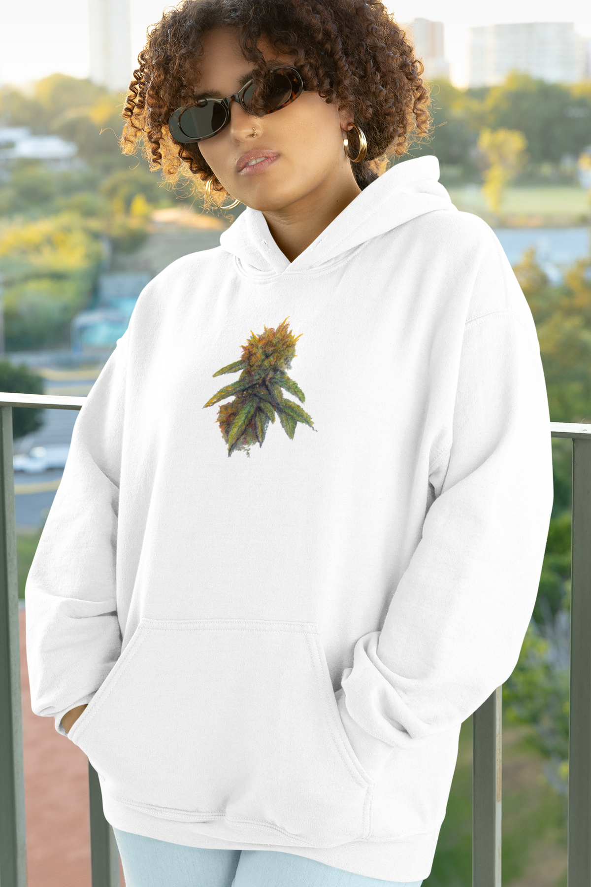 Unisex white pullover hoodie with a colorful cannabis leaf graphic on the chest sizes S-2XL