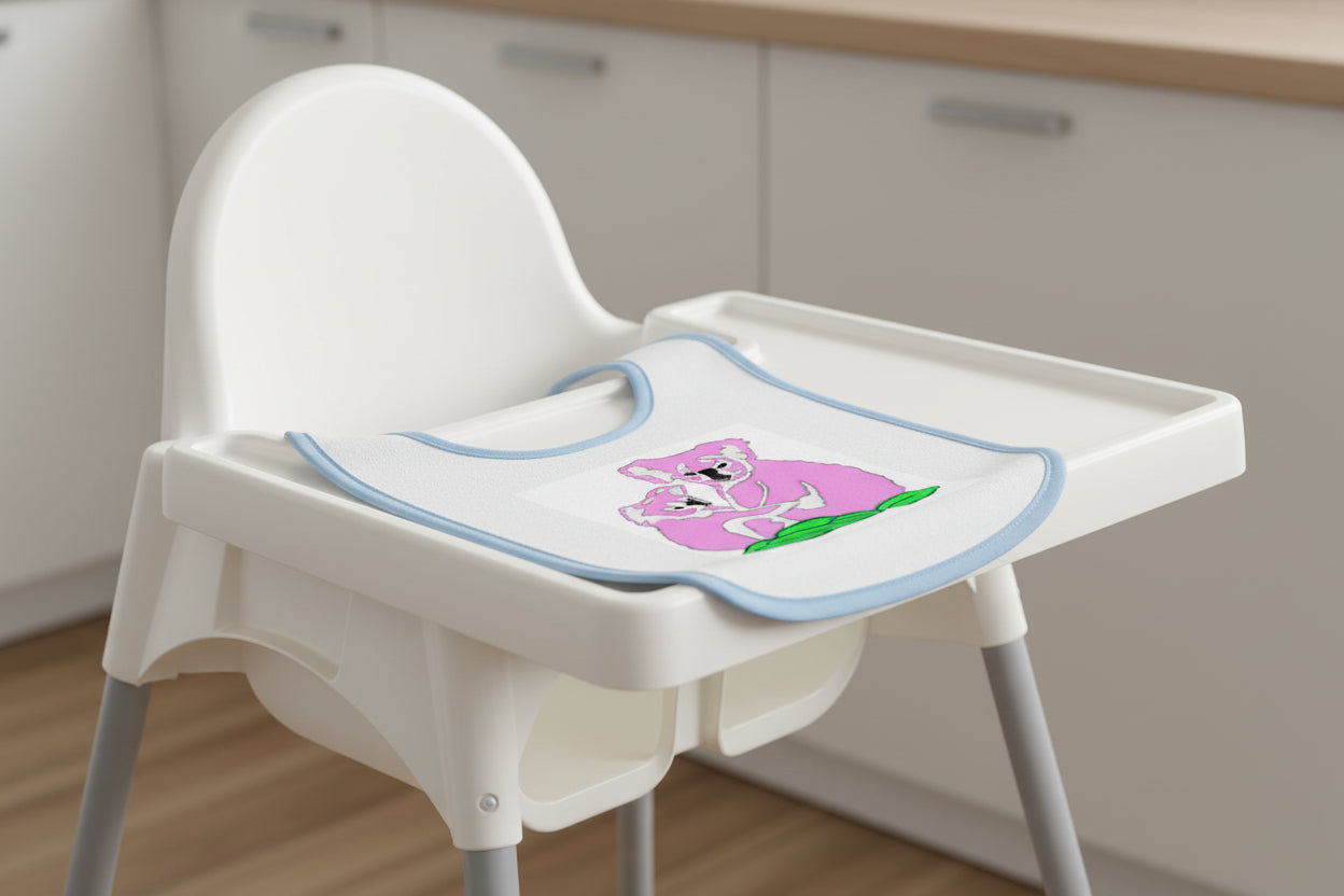 Baby bib with pink koala design on a white background and blue trim 